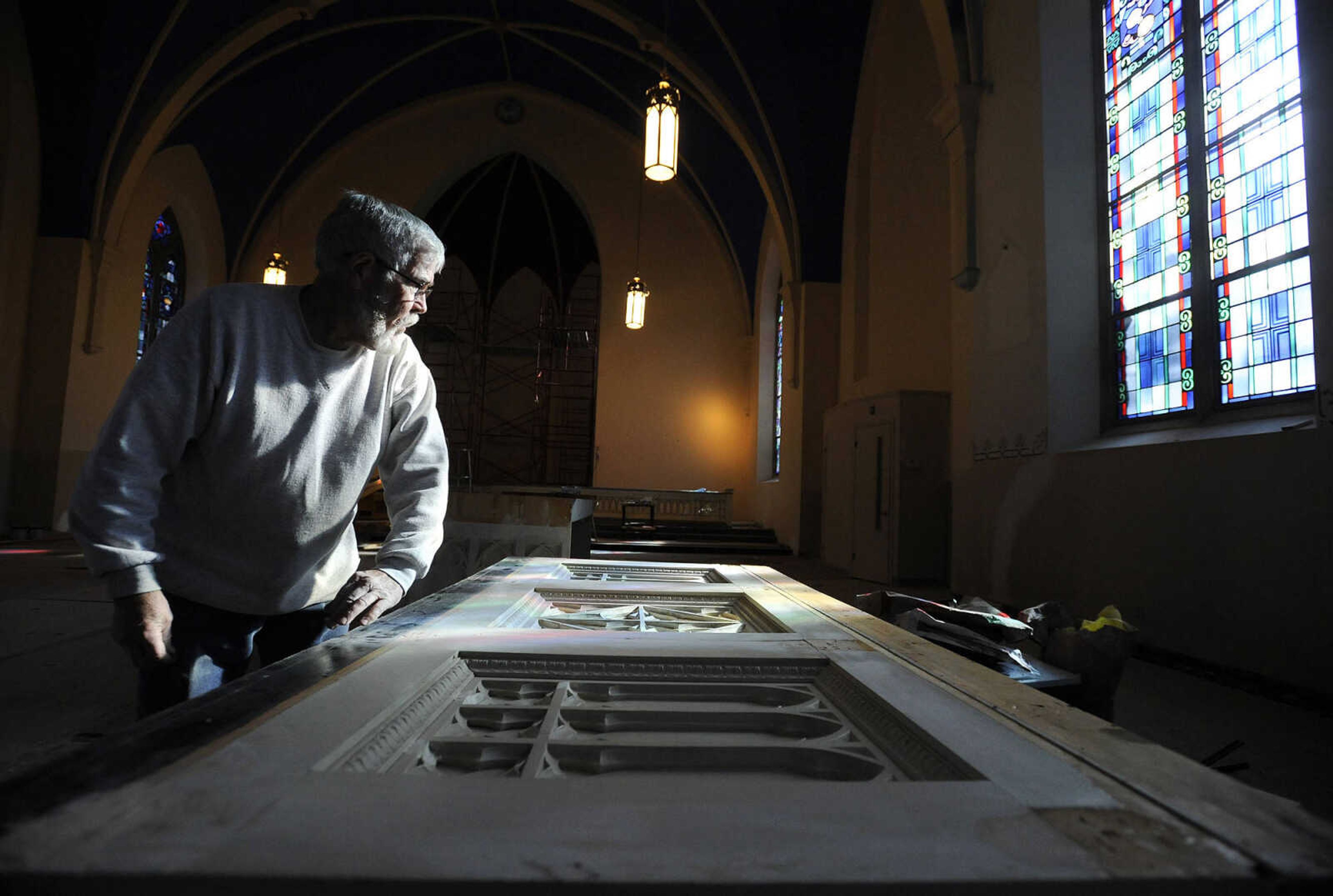 Nick Elfrink looks over one of the altars he and his wife, Geri, are rehabbing inside St. John's Catholic Church in Leopold, Missouri on Feb. 11, 2016. 