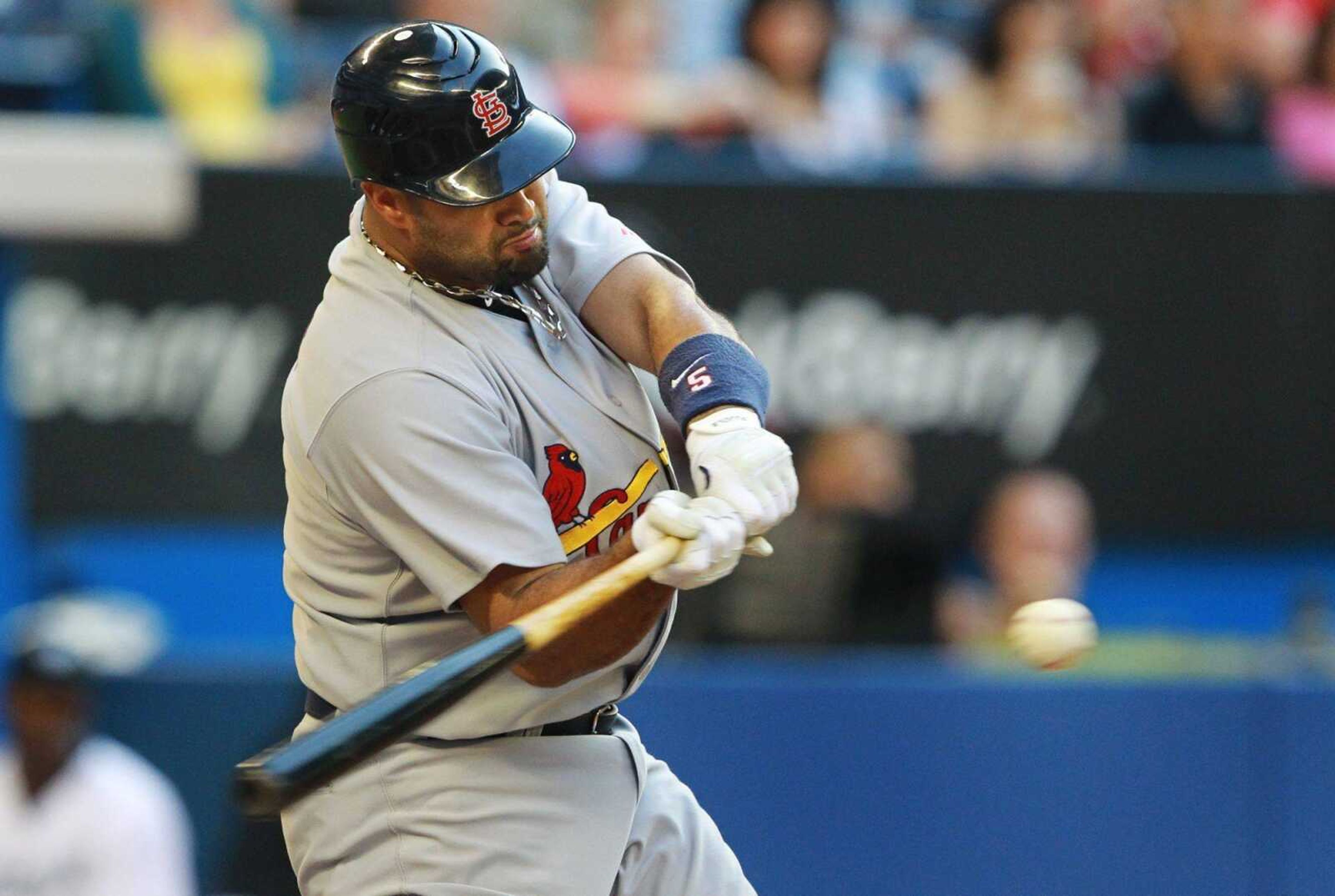 Cardinals first baseman Albert Pujols hits a single during the second inning Wednesday in Toronto. (DARREN CALABRESE ~ Canadian Press)