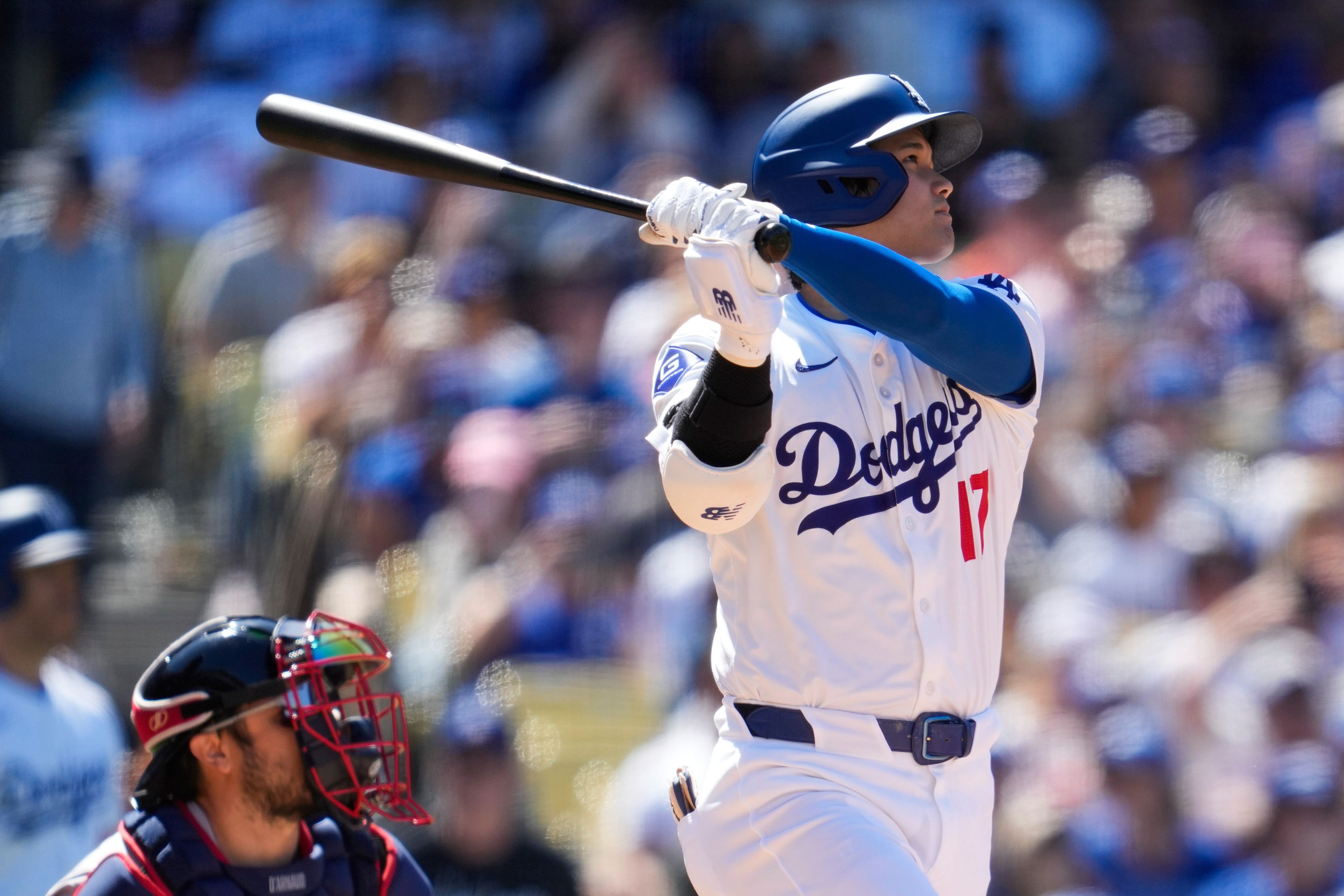 Los Angeles Dodgers designated hitter Shohei Ohtani (17) hits a home run during the eighth inning of a baseball game against the Atlanta Braves in Los Angeles, Sunday, May 5, 2024. (AP Photo/Ashley Landis)