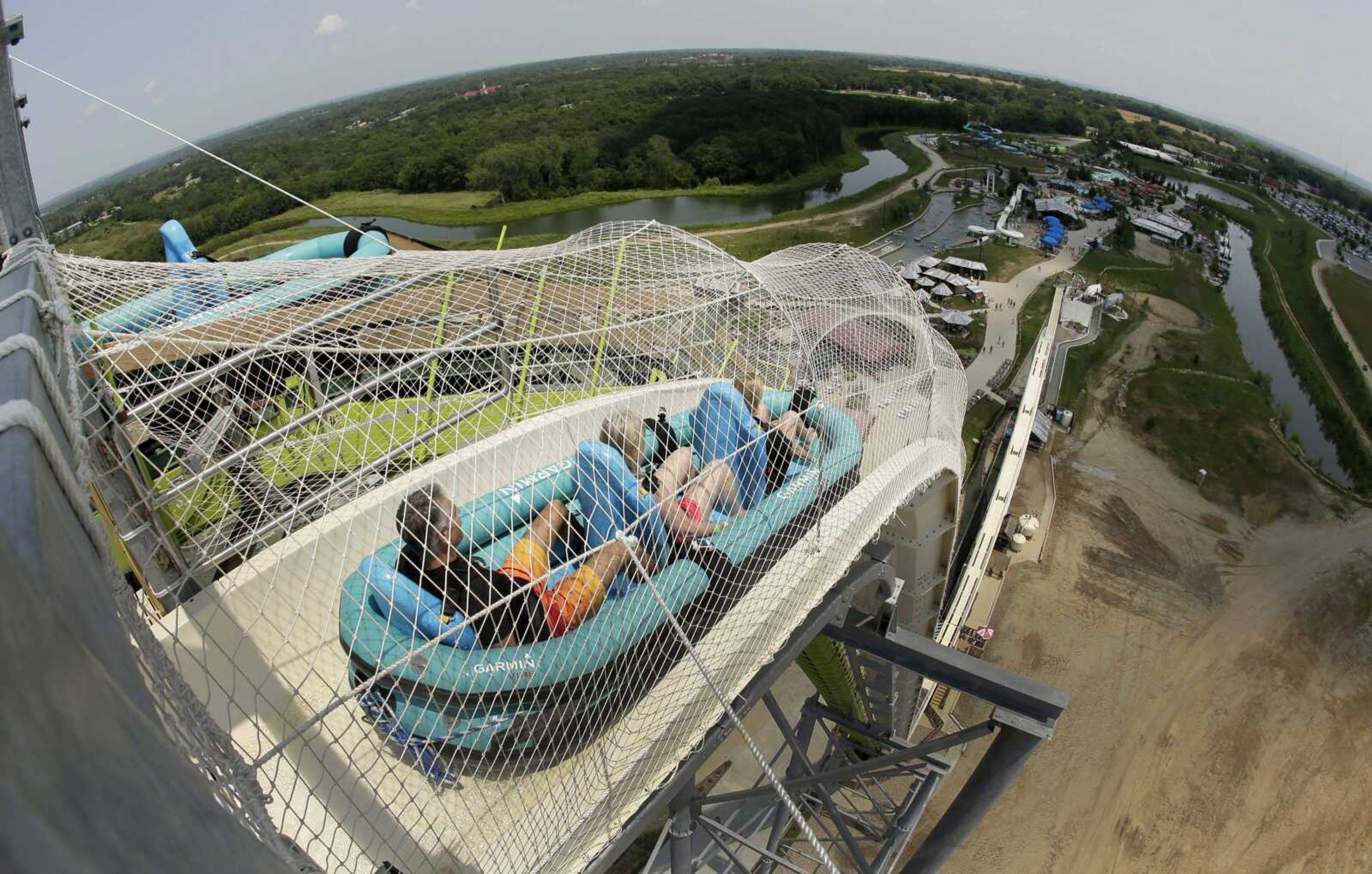 Riders go down the water slide called "Verruckt" on July 9, 2014, at Schlitterbahn Waterpark in Kansas City, Kansas. The family of Caleb Schwab, a Kansas lawmaker's son who was killed on the ride Aug. 7, has reached a settlement with the park's owner.