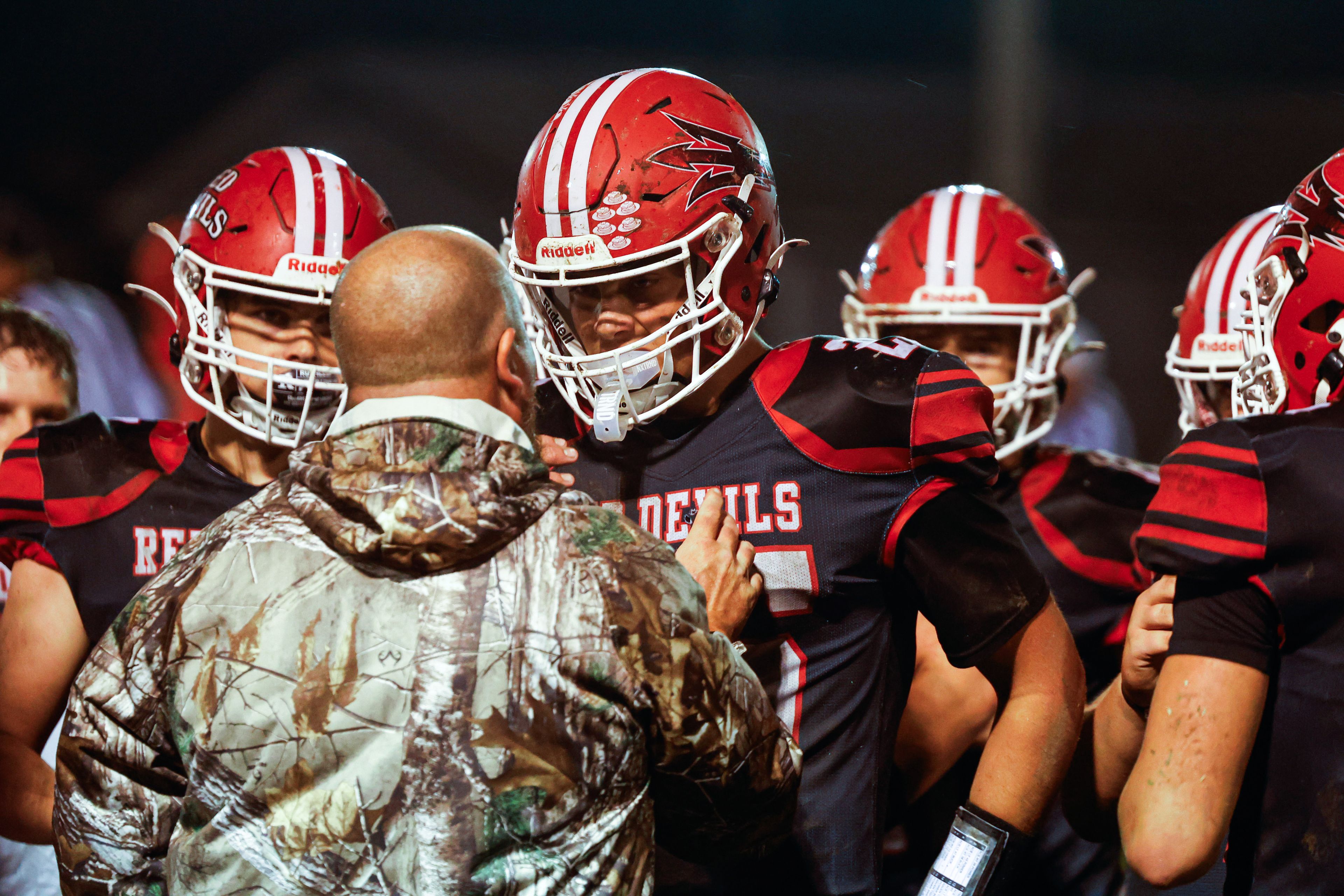 Chaffee head coach, Jack Altermatt, speaks with the team in a dire huddle at the beginning of the 4th quarter at Chaffee High School on Friday, September 27th.