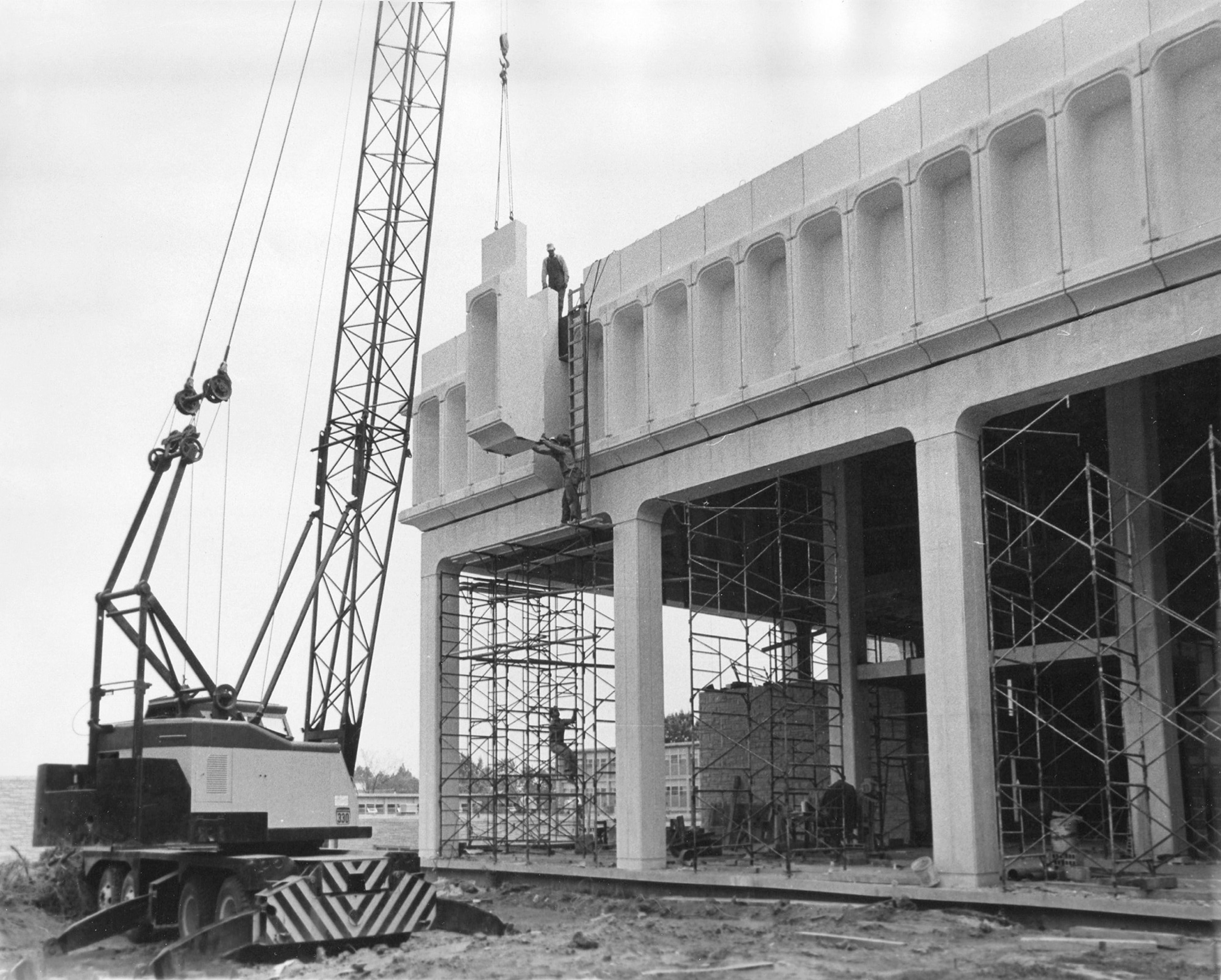 This unpublished photo shows the last of the 96 pre-cast concrete pieces being installed in the front portico of Kent Library on July 15, 1967. The library was undergoing a major expansion that summer.