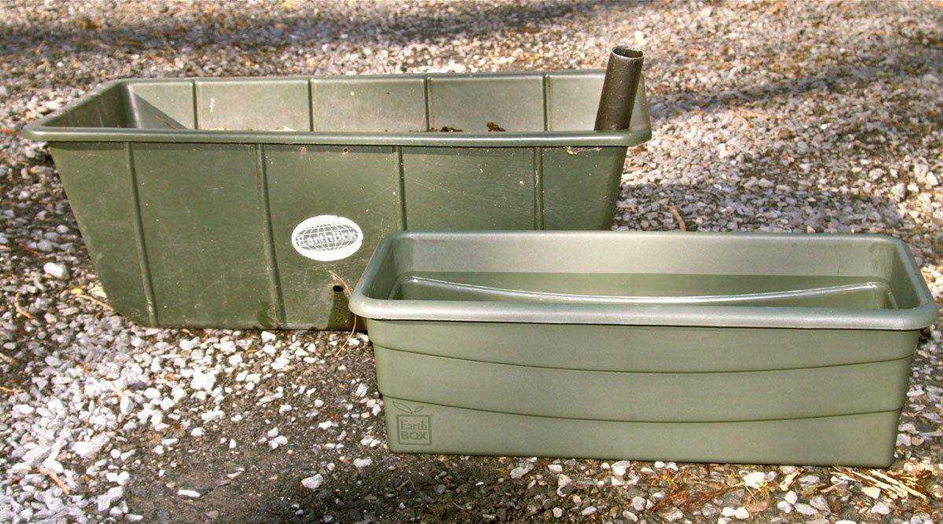 Two EarthBox self-watering gardening containers are shown in a backyard in New Market, Va. (Dean Fosdick ~ Associated Press)