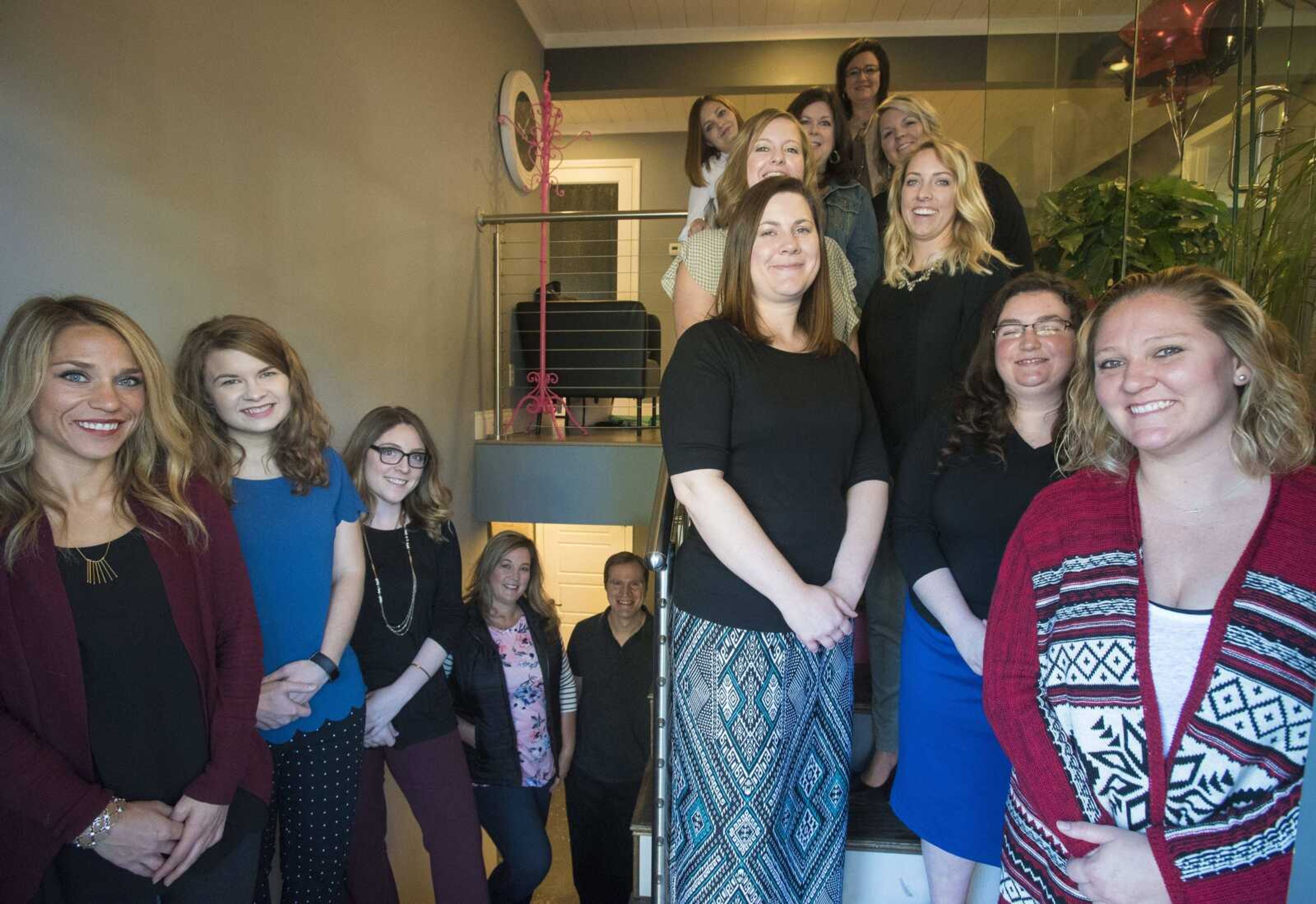 Cutline-Body Copy:Employees with BOLD! Marketing pose for a photo in her office Thursday, Nov. 9, in Cape Girardeau.