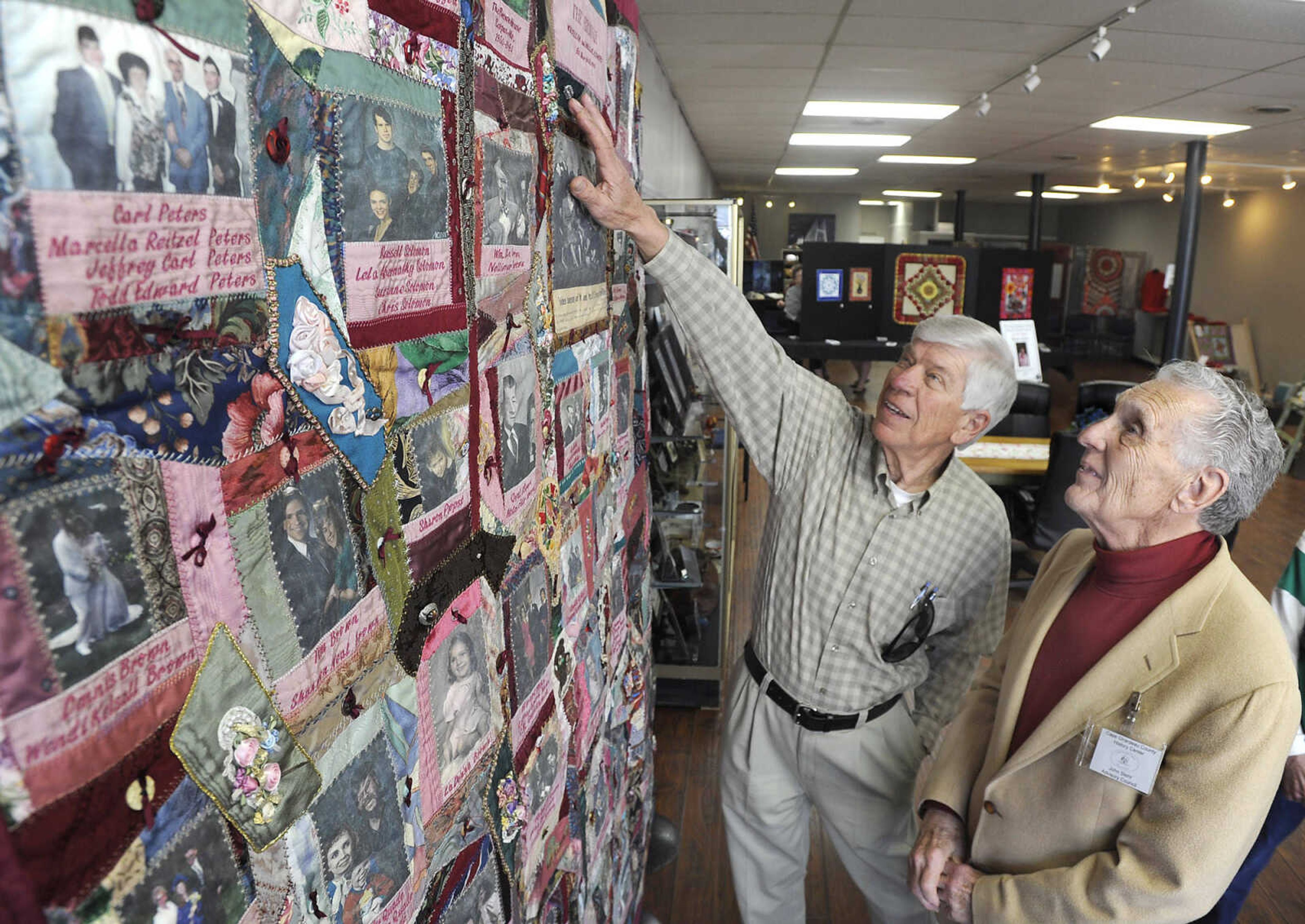 FRED LYNCH ~ flynch@semissourian.com
Len Fiedler, left, and John Stehr admire the Brown Family Quilt, a crazy quilt designed and created by Idell Brown Dockins, Sunday, March 15, 2015 at the new Cape Girardeau County History Center in Jackson.