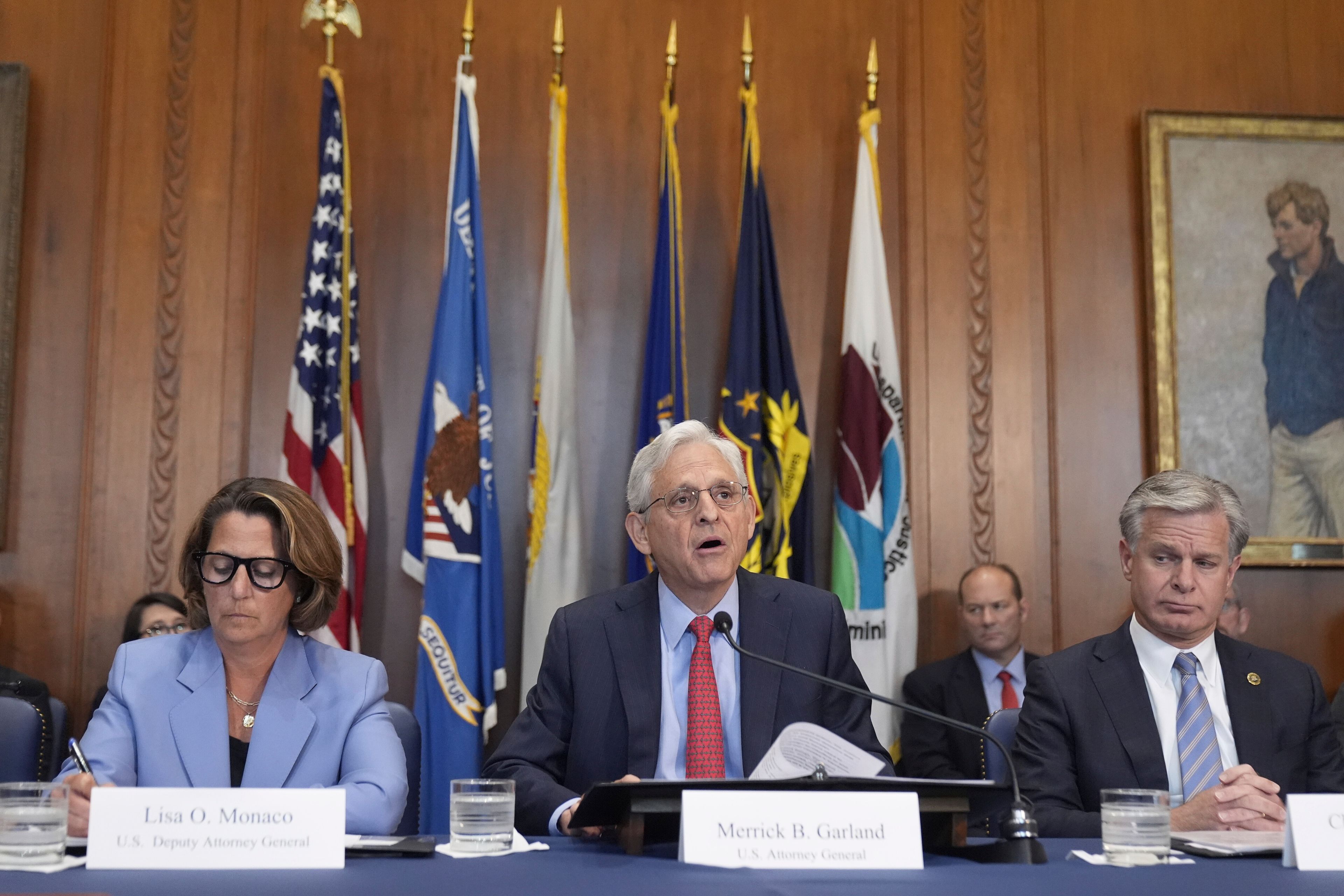 Attorney General Merrick Garland speaks during a meeting of the Justice Department's Election Threats Task Force, at the Department of Justice, Wednesday, Sept. 4, 2024, in Washington, with Deputy Attorney General Lisa Monaco, left, and FBI Director Christopher Wray, right. (AP Photo/Mark Schiefelbein)