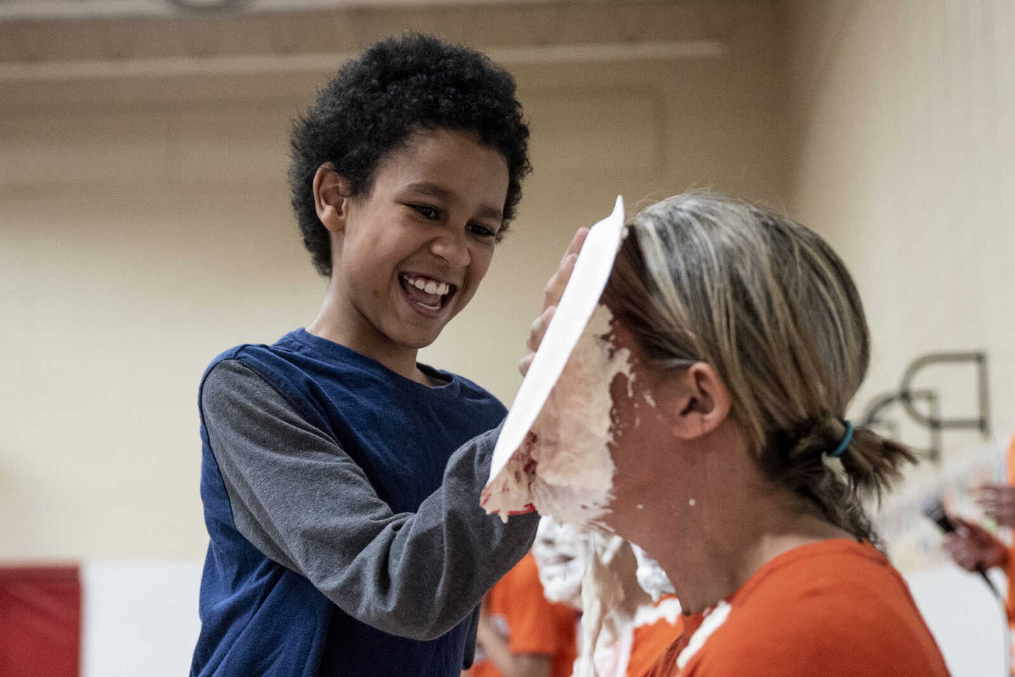 Third grader Xavier Artis pies Amy Emmenderfer in the face at Clippard Elementary School Friday, April 5, 2019, in Cape Girardeau. Students earned votes for which teacher(s) would get pied in the face when they brought in donations to raise money for their end-of-the-year play day that is free to students. Through students and other donations, the school raised $550 towards their play day activities.