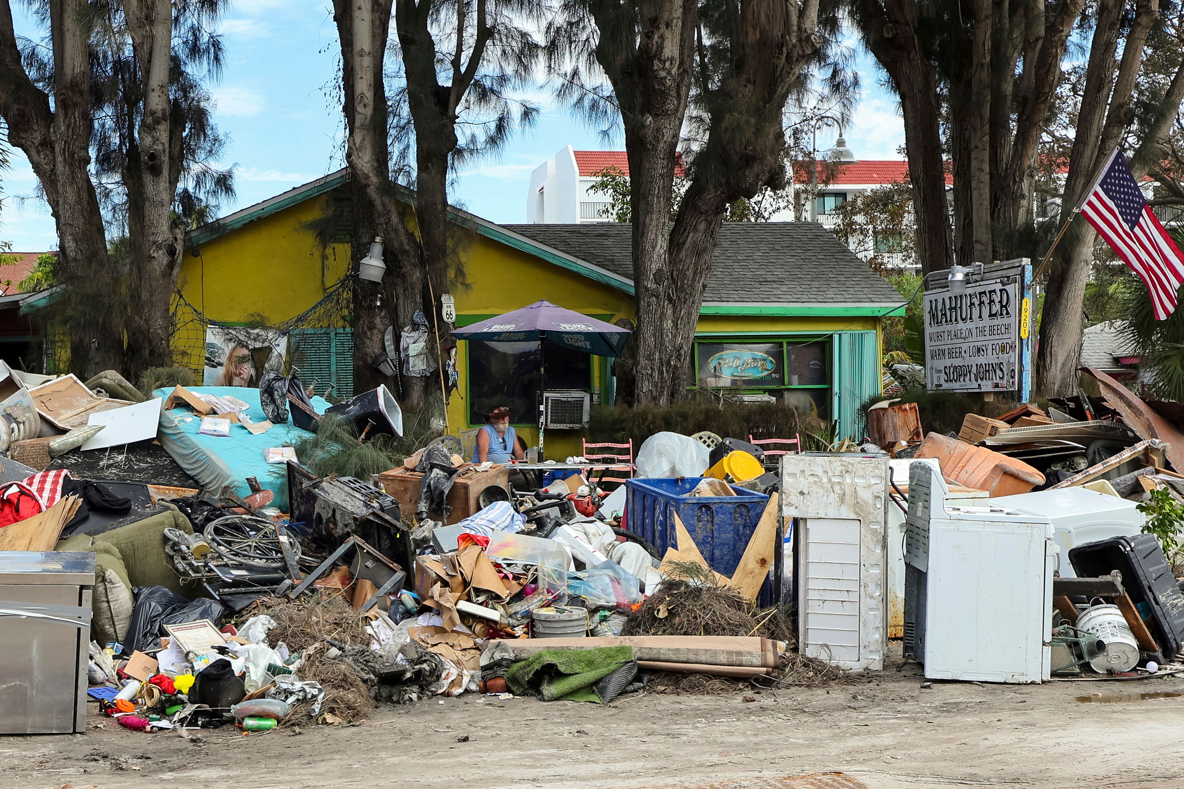 The contents from Mahuffer is on the side of the street after being removed from the flooding of Hurricane Helene on Wednesday, Oct. 2, 2024, in Indian Rocks Beach, Fla. (AP Photo/Mike Carlson)