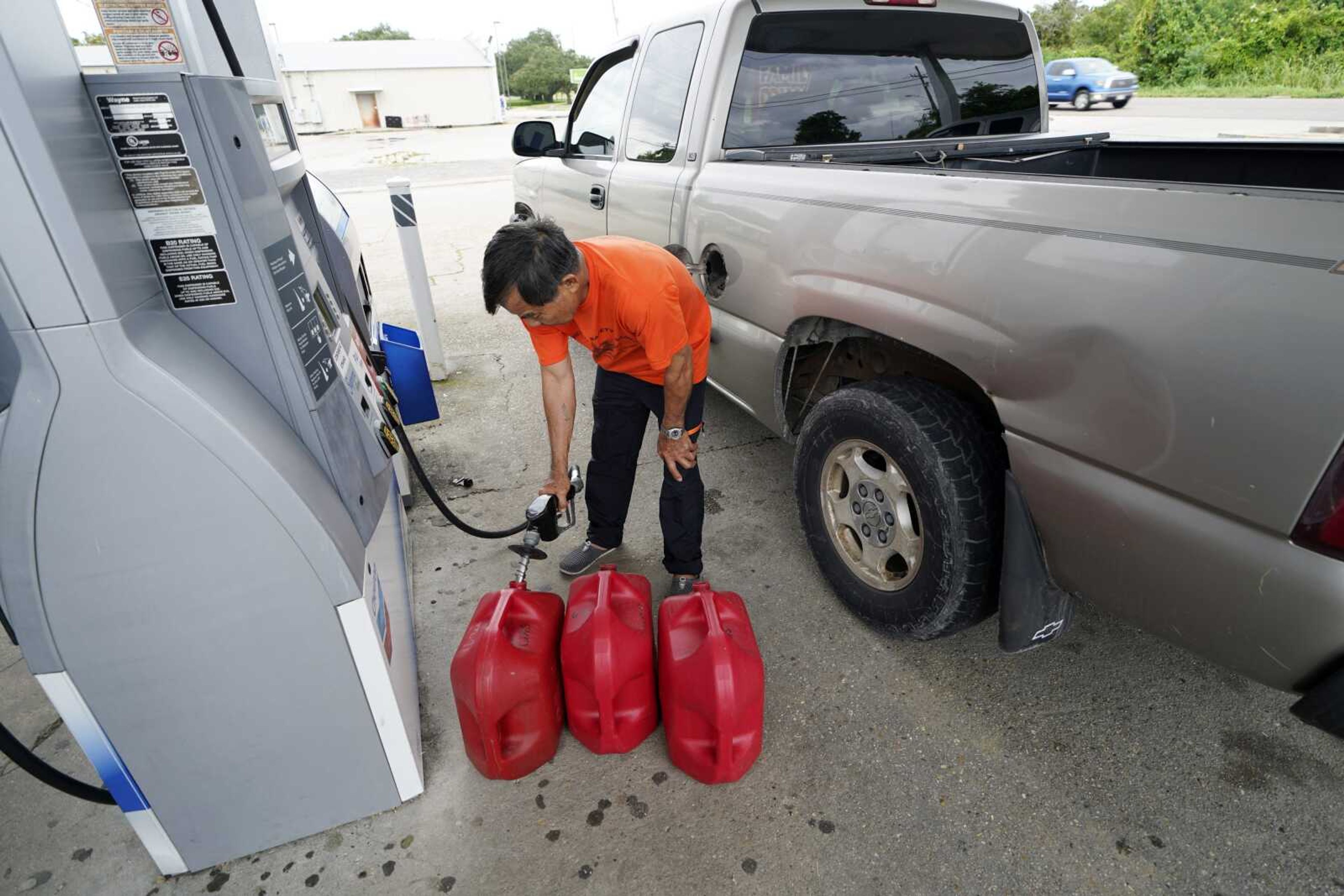 Robert Nguyen buys gas for his generator Sunday in Port Sulphur, Louisiana, in advance of Hurricane Marco, expected to make landfall on the Southern Louisiana coast.