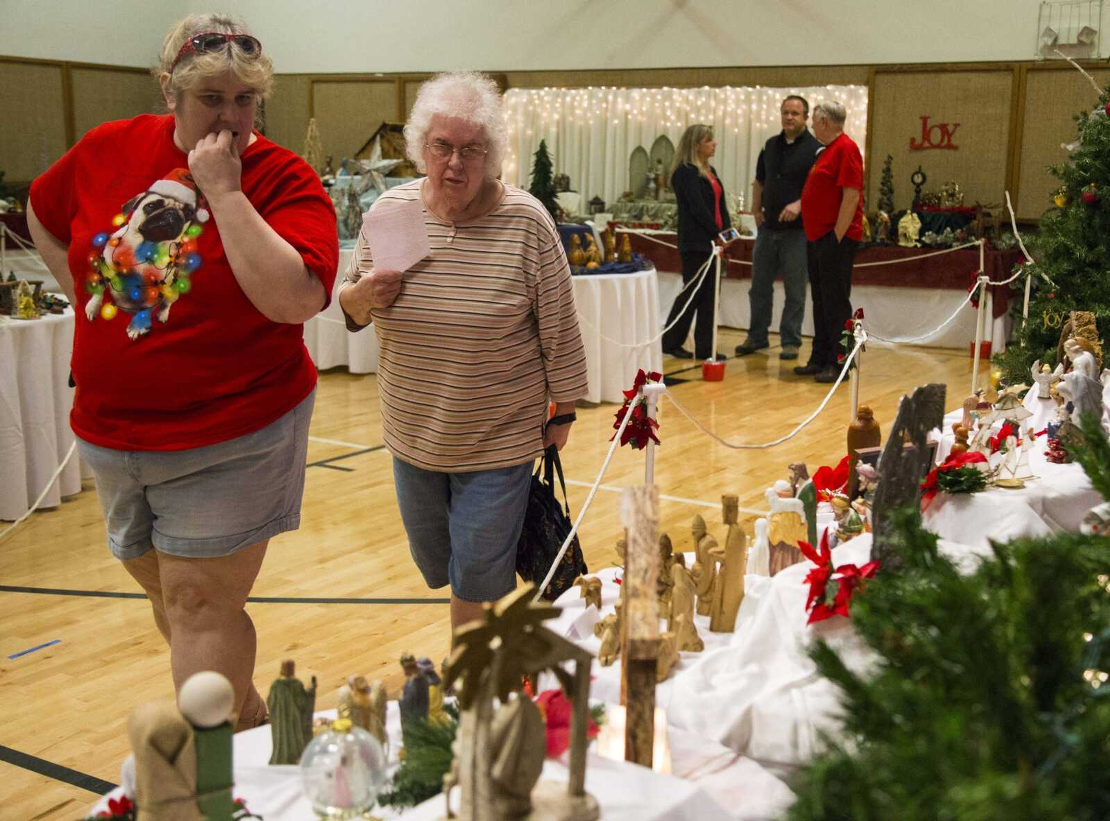 Rhonda Kilburn, left, and Helen Ireland view nativity scenes in a gymnasium exhibit Saturday, Dec. 2, 2017, during the sixth annual Nativities From Around the World exhibition at the Church of Jesus Christ of Latter-Day Saints in Cape Girardeau.