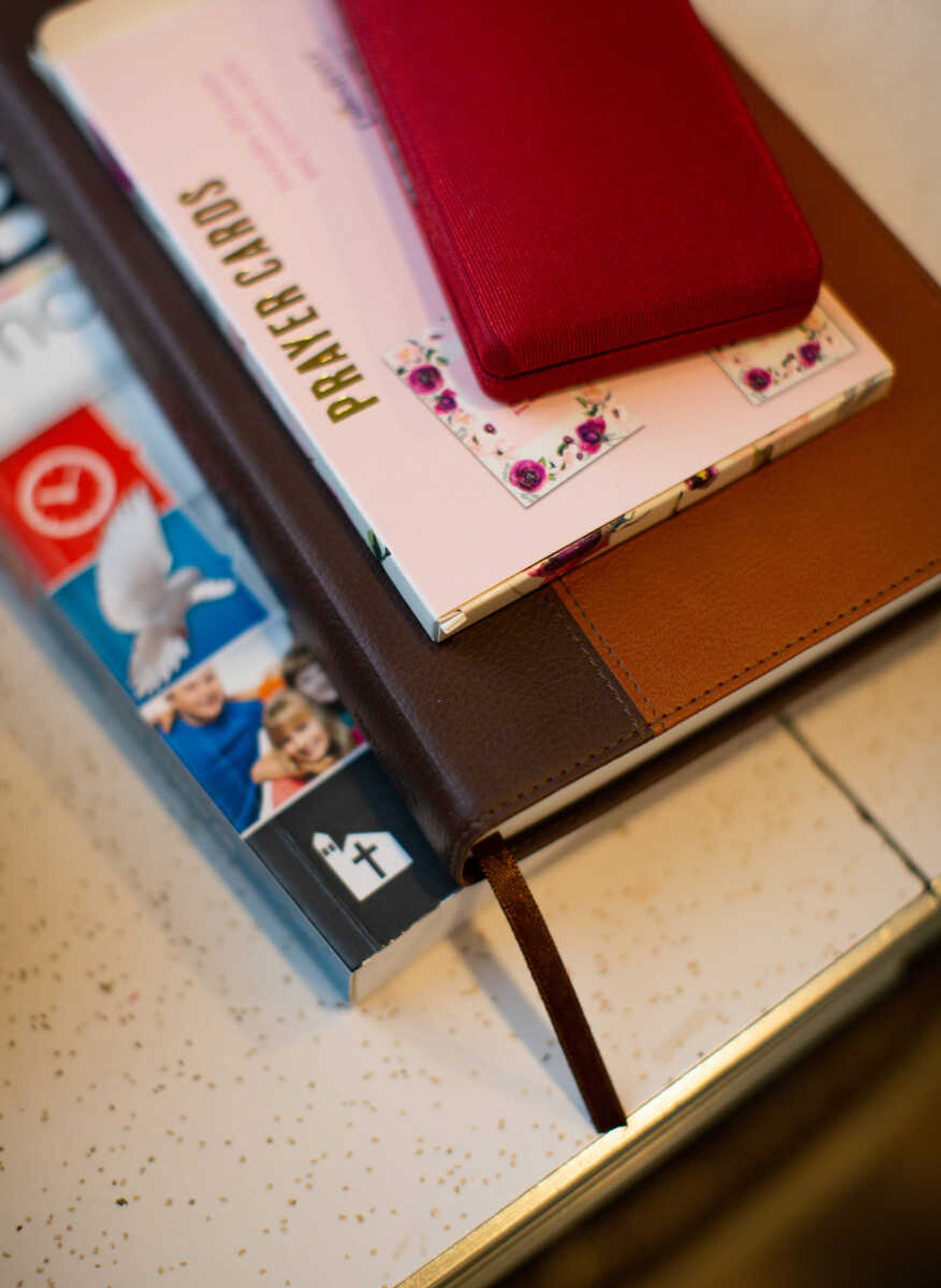 Reading materials where Marilyn Morgan finds inspiration are collected on a table near her desk. Morgan decided to share her experiences through writing to encourage people during the pandemic.