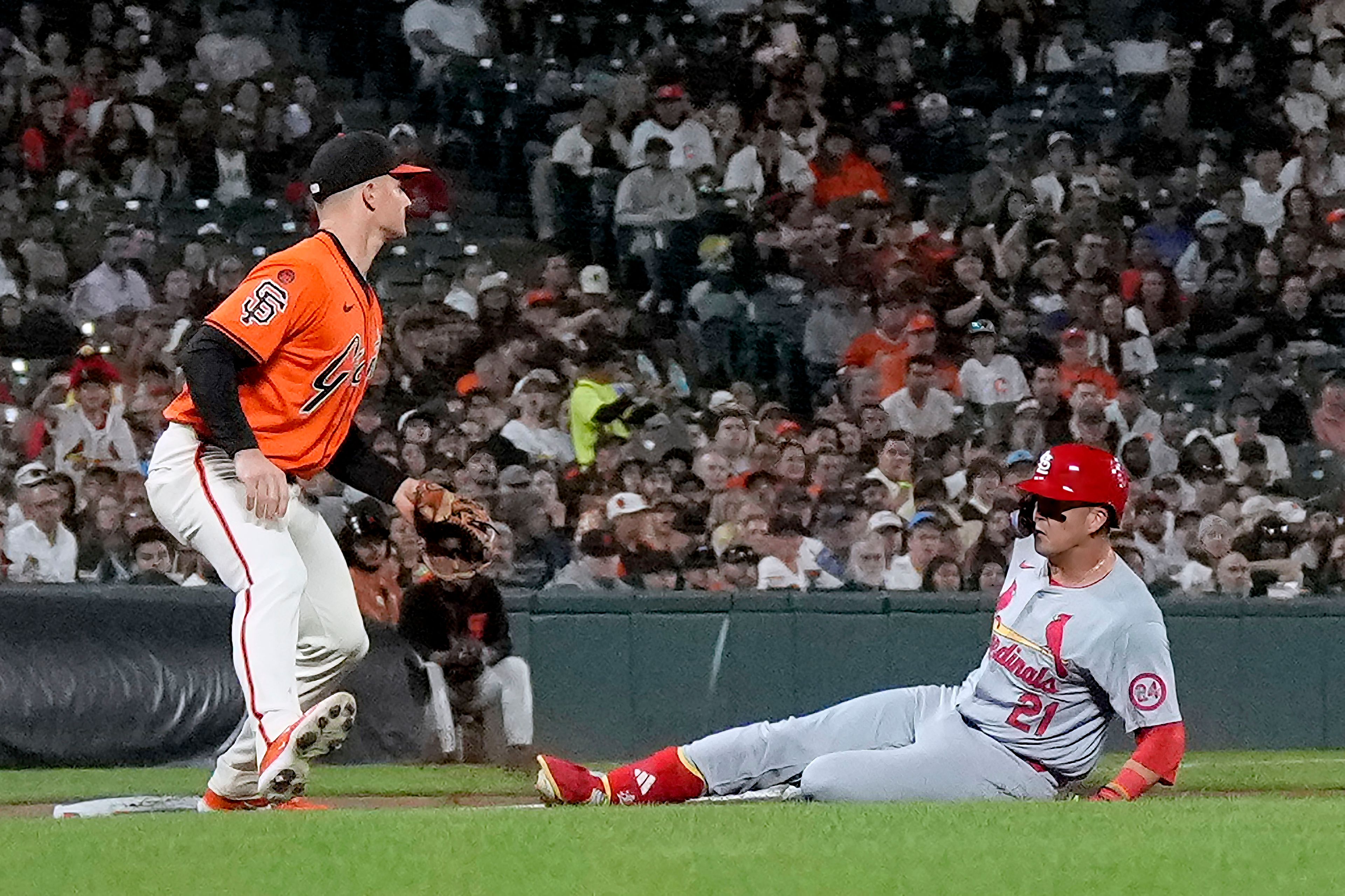 St. Louis Cardinals' Lars Nootbaar (21) slides safely into third base after hitting a two-RBI triple against the San Francisco Giants during the fourth inning of a baseball game Friday, Sept. 27, 2024, in San Francisco. (AP Photo/Tony Avelar)