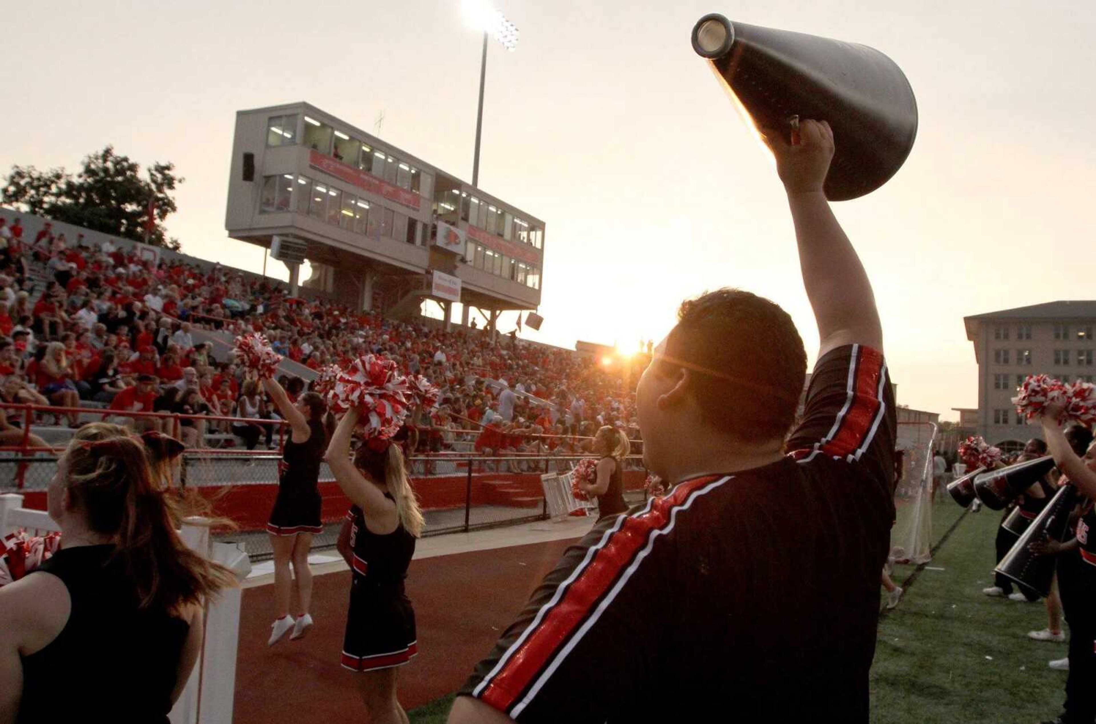 Southeast Missouri State cheer squad member Juan Salas raises a megaphone during a cheer at the season opener last season. (Glenn Landberg)