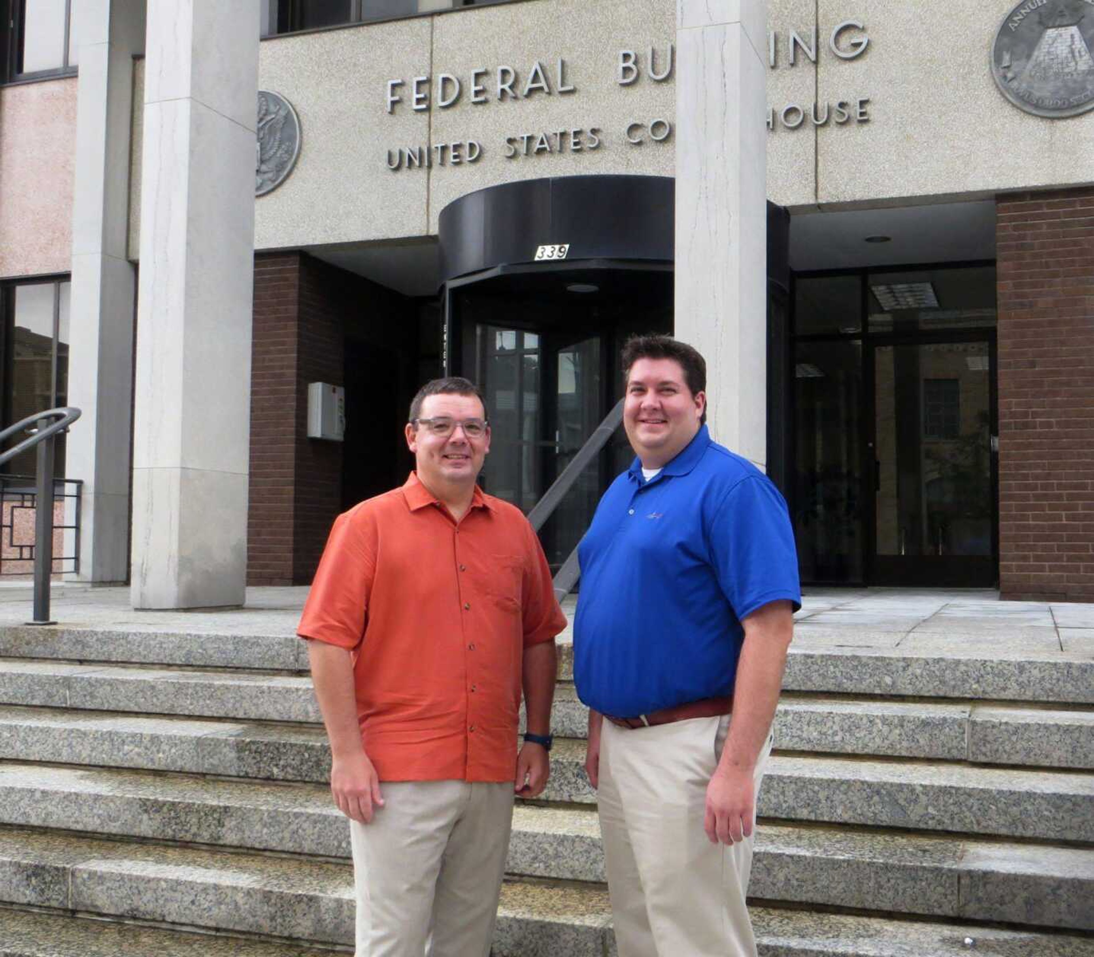 Dr. James Stapleton, left, and Chris Foeste stand in front of the former federal building, home to their new co-working business, Codefi. (Samantha Rinehart)