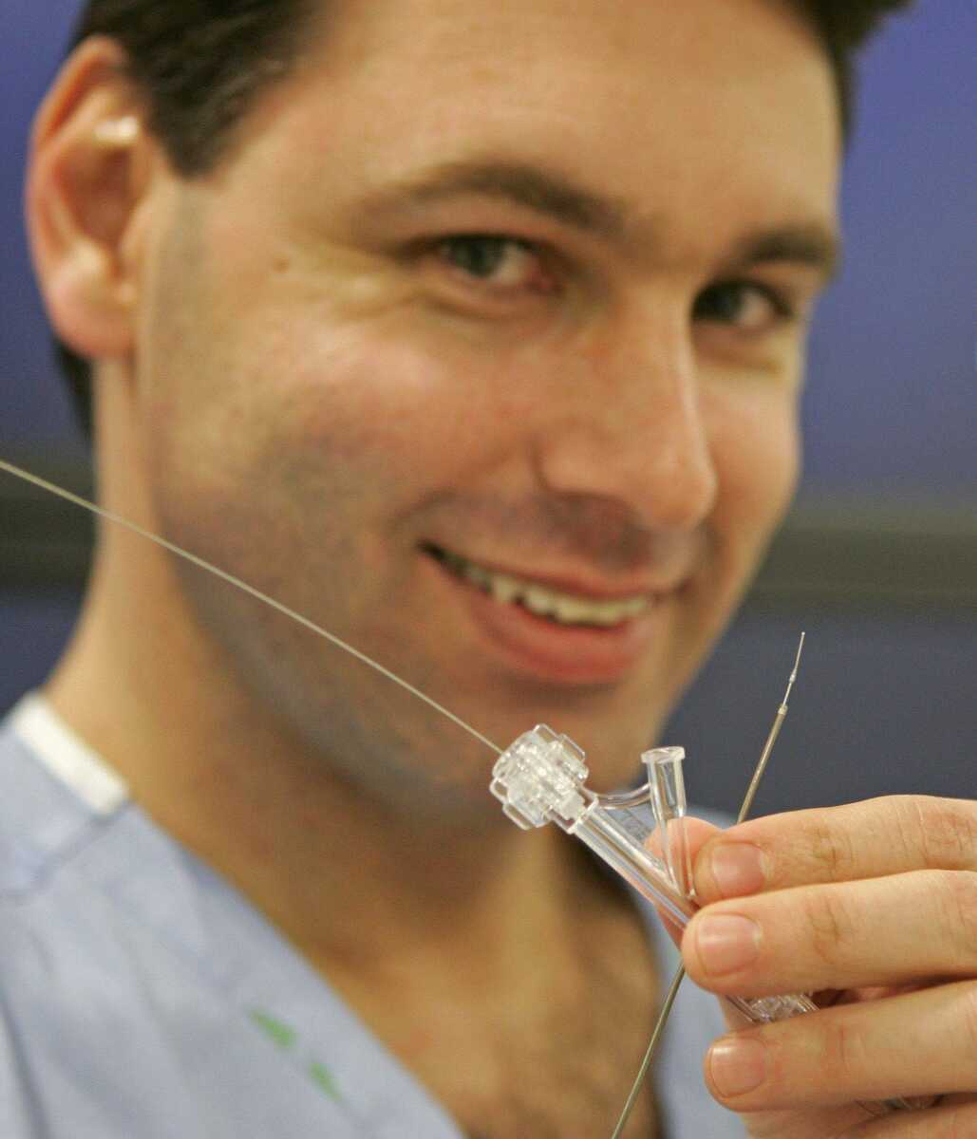 Rush Medical Center neurosurgeon Demetrius Lopes holds up a Penumbra stroke vacuum system, Friday, Jan. 25, 2008, in Chicago. A tiny vacuum cleaner for the brain is the newest treatment for stroke victims, promising to literally suction out clogged arteries to get blood flowing again. Now the question is how to tell which patients are good candidates _ because illogical as it may sound, unclogging isn't always the best option to treat strokes, the nation's No. 3 killer. (AP Photo/Jerry Lai)