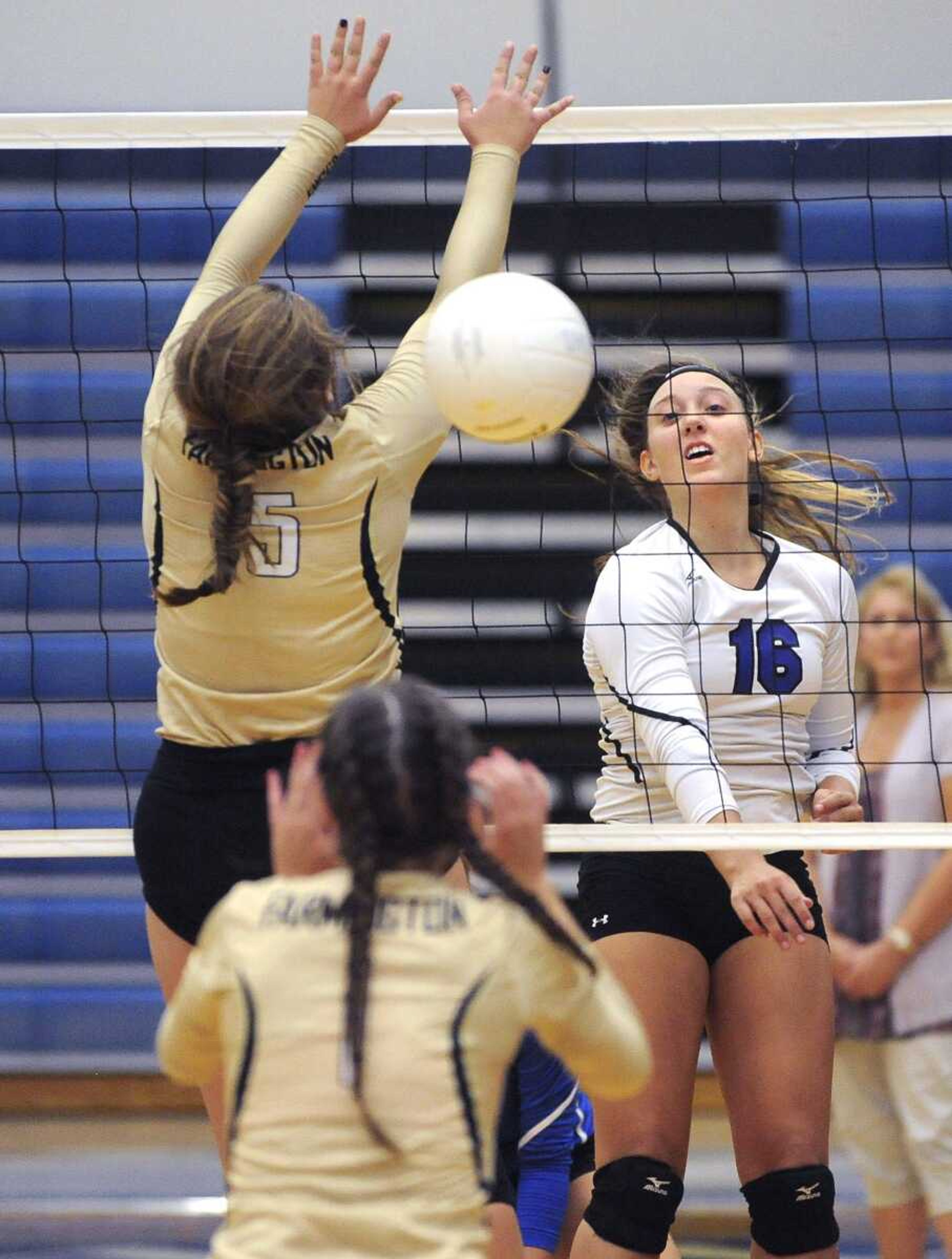 Notre Dame's Lexi Welter spikes the ball past Farmington's DeShay Tate during the third set Thursday at Notre Dame Regional High School.