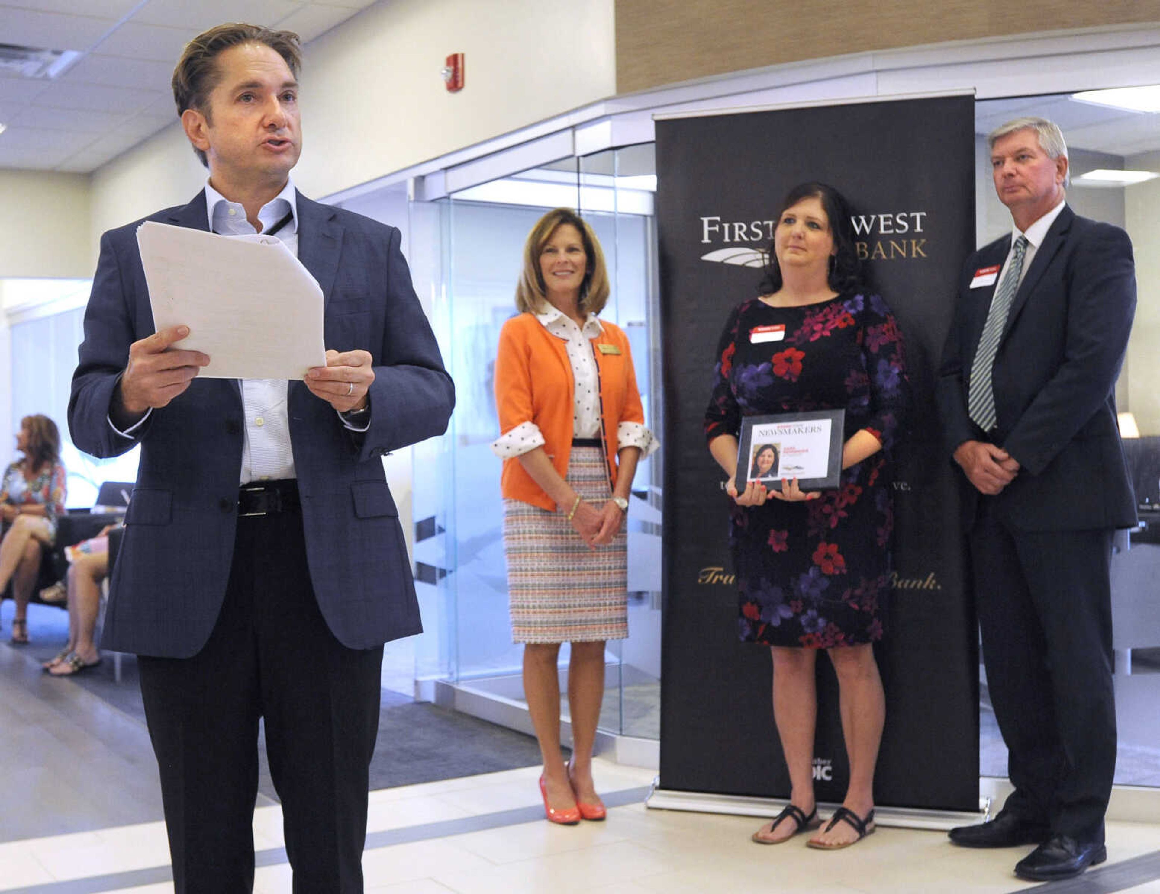 FRED LYNCH ~ flynch@semissourian.com
Jon K. Rust, publisher of the Southeast Missourian and co-president of Rust Communications, recognizes Sara Nenninger, one of the Business Today Newsmakers honored Wednesday, Sept. 6, 2017 during an awards reception at First Midwest Bank in Cape Girardeau. Nenninger stands with Kathy Bertrand, First Midwest Bank community bank president, Cape Girardeau, and John N. Thompson, First Midwest Bank community bank president, Jackson.