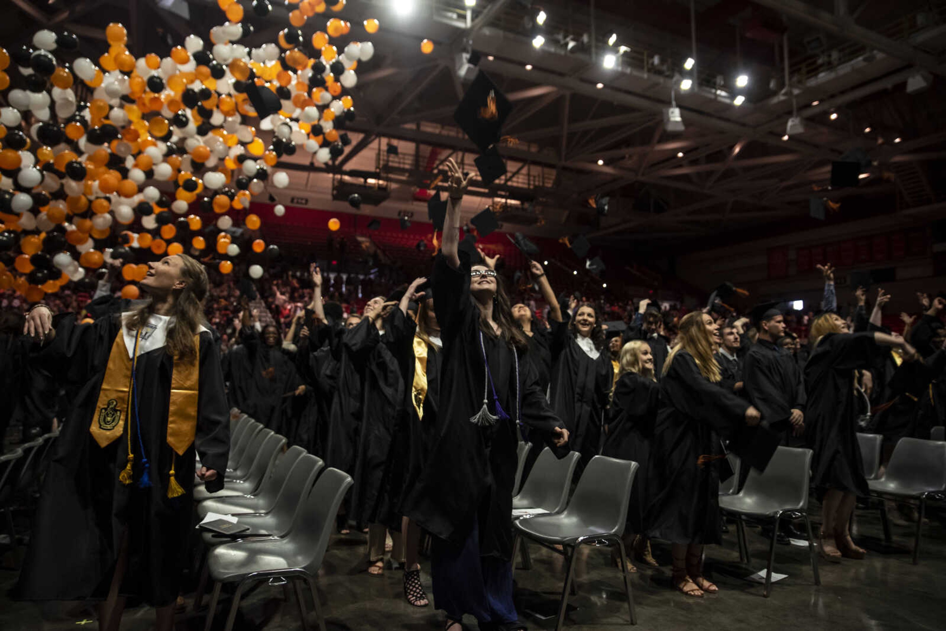 Emily Medlock, center, tosses her hat into the air as balloons drop at the conclusion of the Cape Central High School Class of 2019 Commencement at the Show Me Center Sunday, May 12, 2019, in Cape Girardeau.