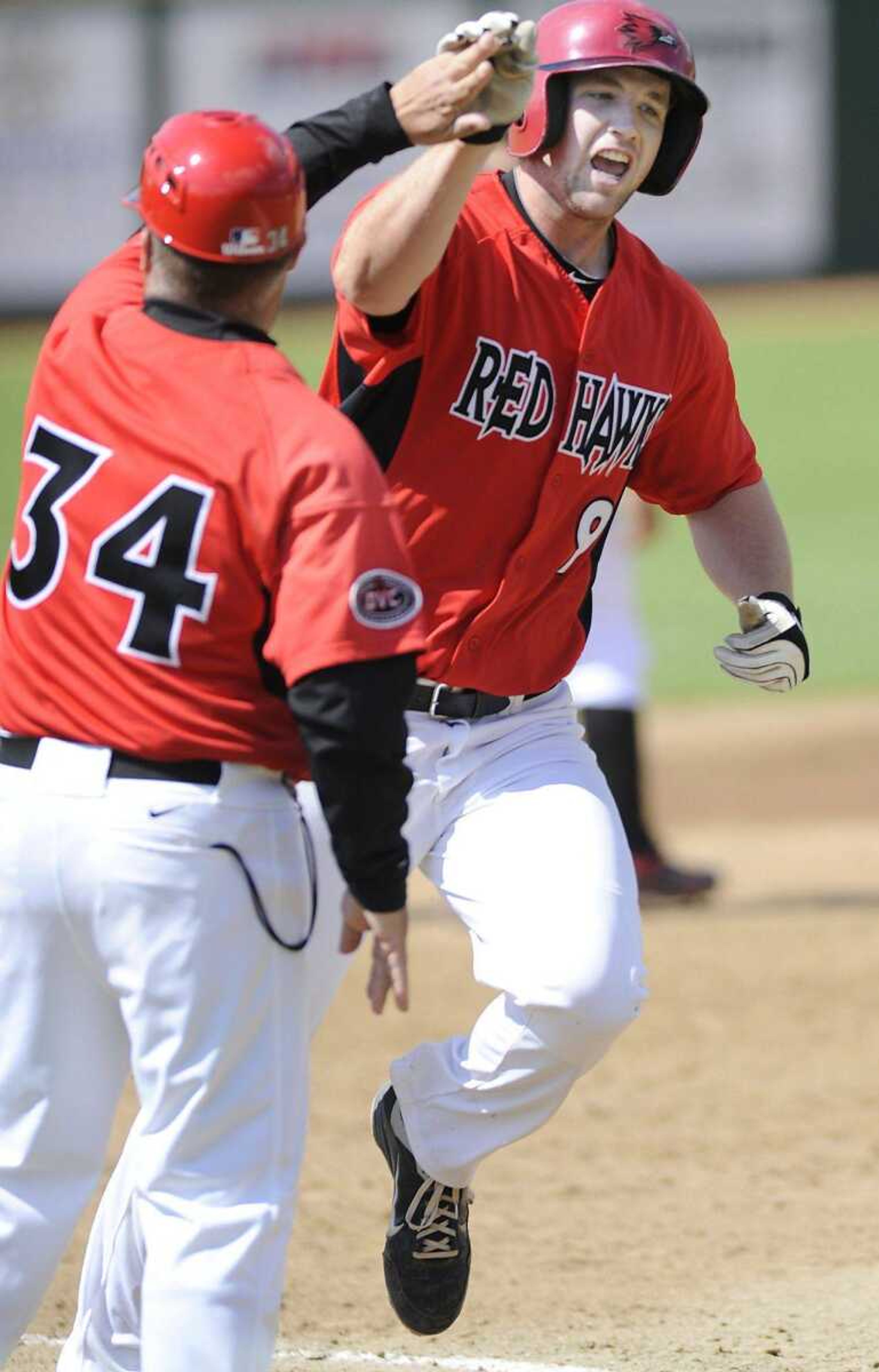 Southeast Missouri State third baseman Trenton Moses high-fives third base coach Chris Cafalone after Moses hit a home run earlier this season. Moses was drafted by the Braves in the 26th round. (ADAM VOGLER)