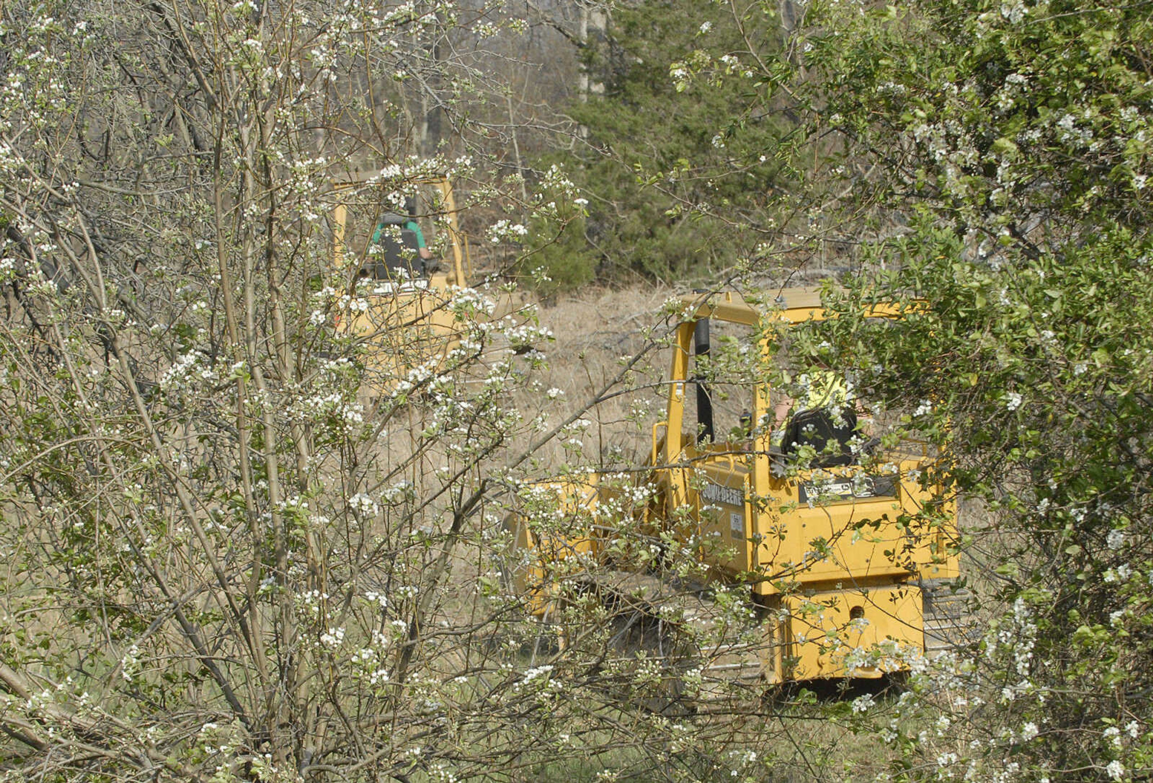 LAURA SIMON~lsimon@semissourian.com
Bulldozers head up the hillside to clear a path for fire crews to help fight a natural cover fire off of Cissus Lane near Neelys Landing Sunday, April 3, 2011. Firefighters from Cape Girardeau, Perry, Scott, and Bollinger Counties contained the blaze that ravaged 50 acres of land.