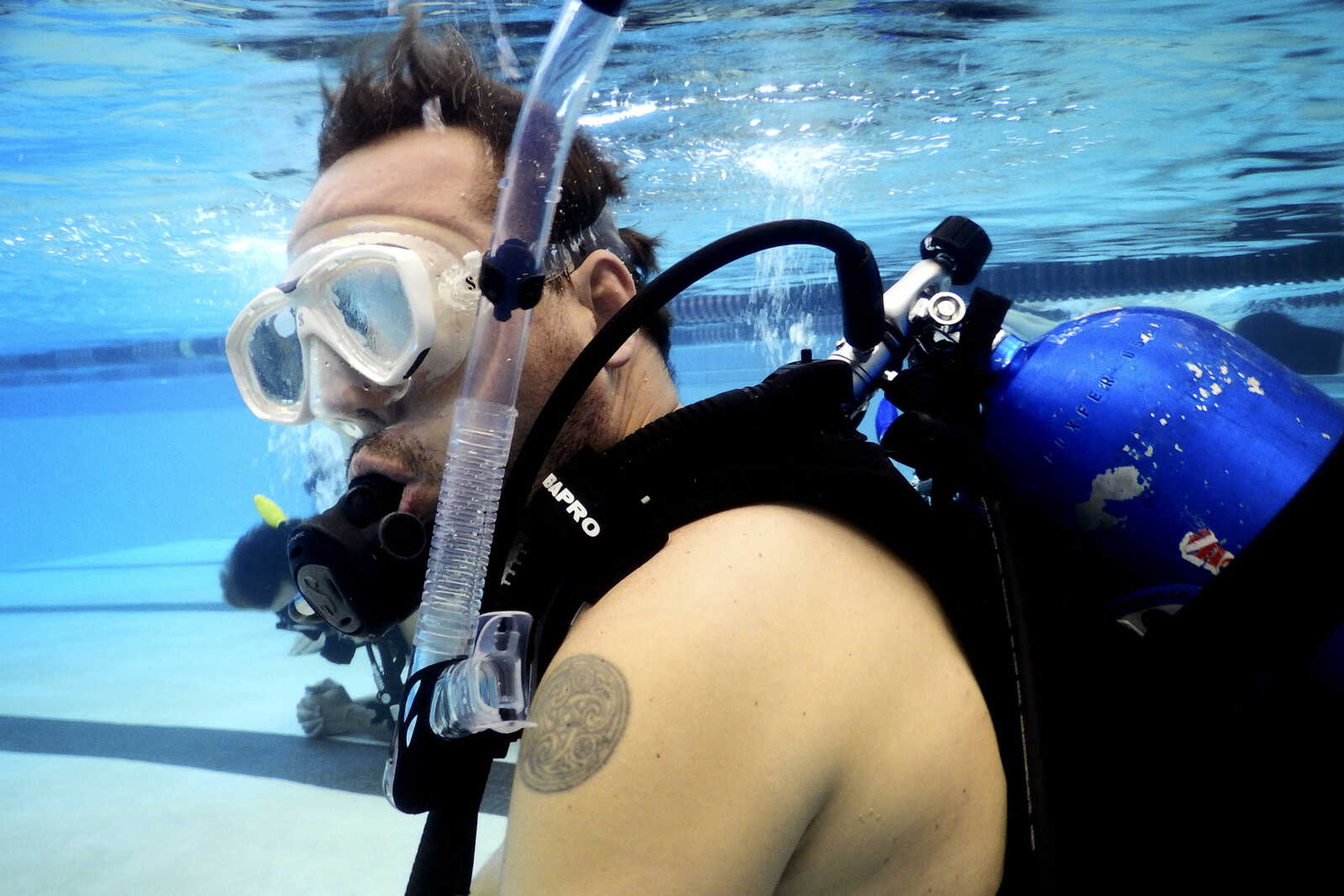 Ryan McLaughlin of Dexter, Missouri, takes part in a scuba diving class with his son Miller McLaughlin, 15, not pictured, Saturday, July 13, 2019, at Southeast Missouri State University's Student Aquatic Center in Cape Girardeau.