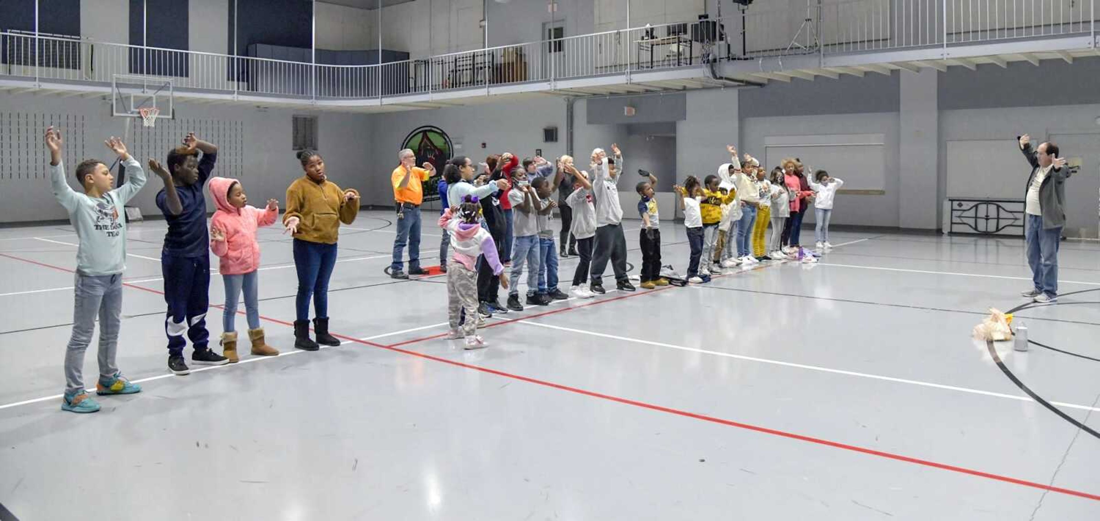 Mike Dumey directs the children from the Boys and Girls Clubs of Cape Girardeau and members of the adult choir Monday for the "Searchlight" program this week at Centenary United Methodist Church in Cape Girardeau.