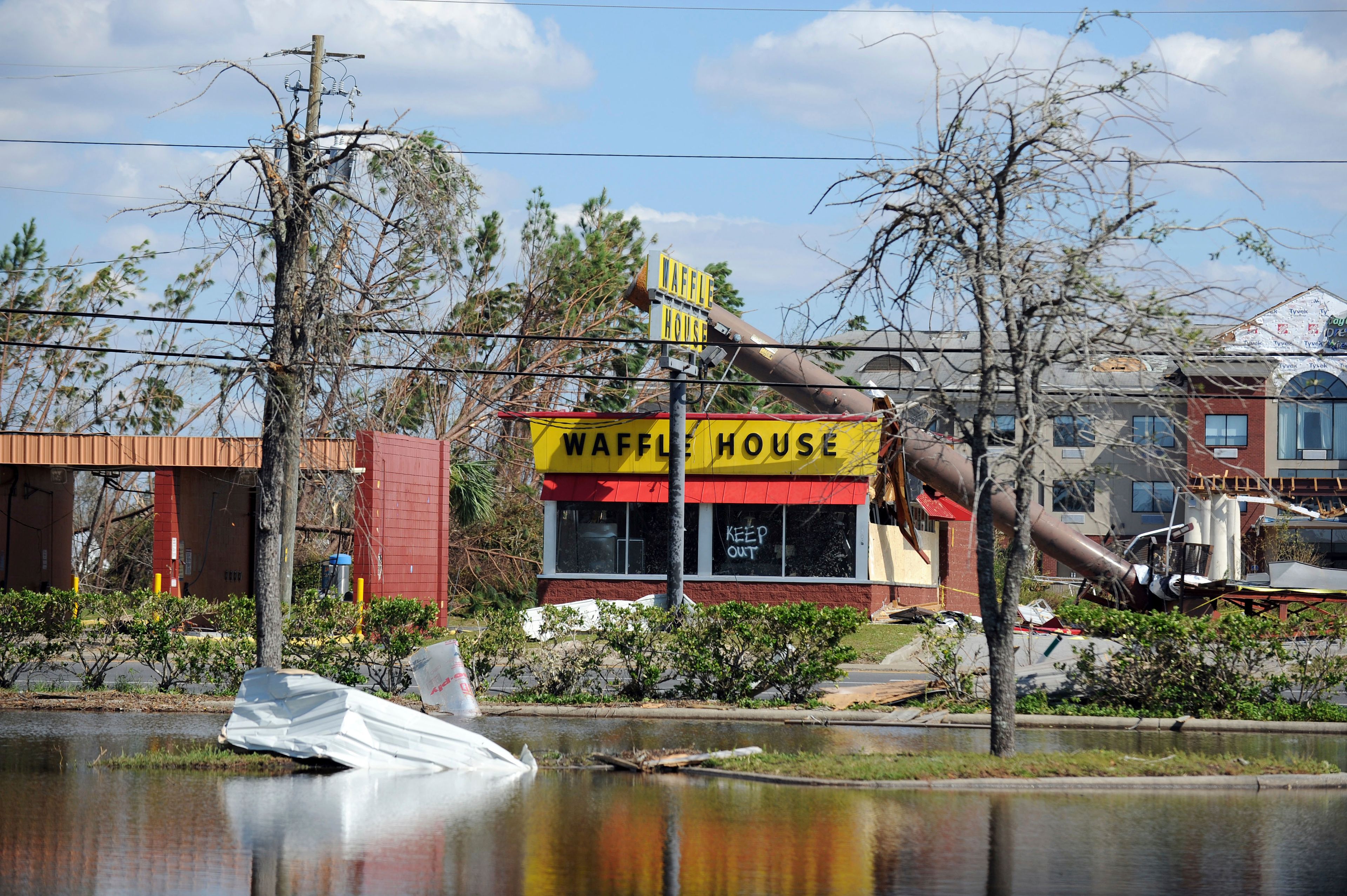 FILE - A billboard lies atop a Waffle House restaurant after being knocked down by Hurricane Michael in Panama City, Fla., Oct. 14, 2018. (Carlos R. Munoz/Sarasota Herald-Tribune via AP, File)