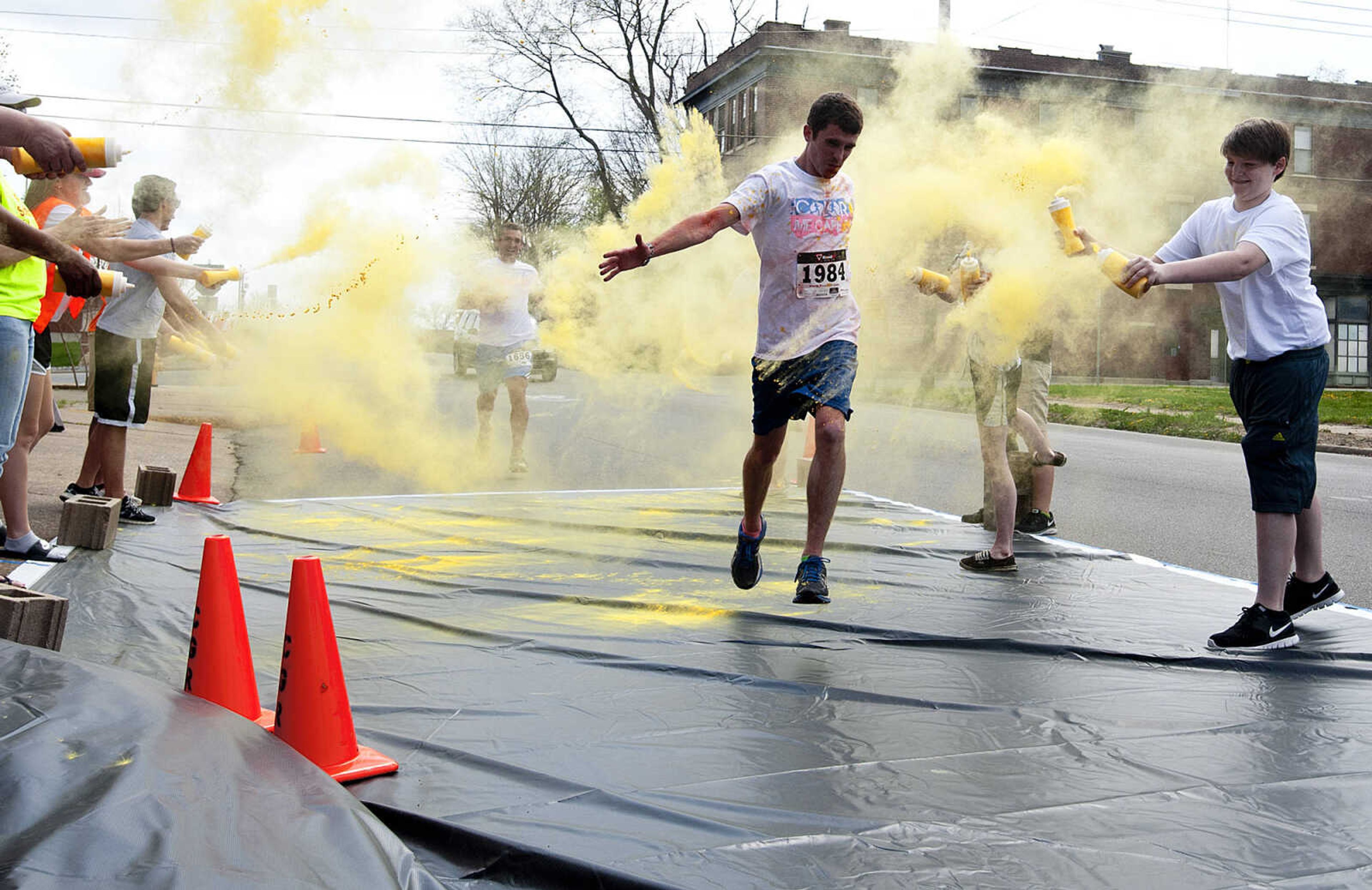 ADAM VOGLER ~ avogler@semissourian.com
Participants in the Color Me Cape 5k run through the yellow color station north of the intersection of Independence Street and Frederick Street Saturday, April 12, in Cape Girardeau.