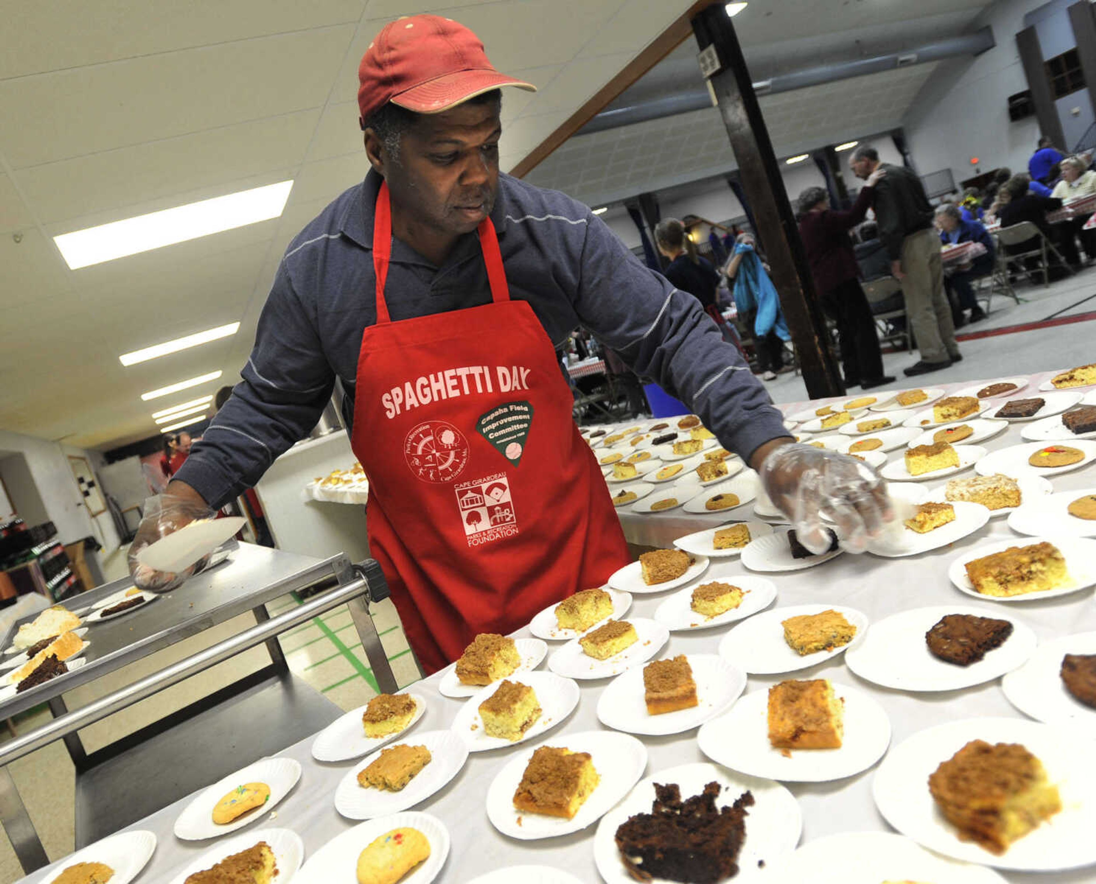 Robert Harris keeps the dessert table filled at the Parks & Recreation Foundation Spaghetti Day Wednesday, Nov. 13, 2013 at the Arena Building.