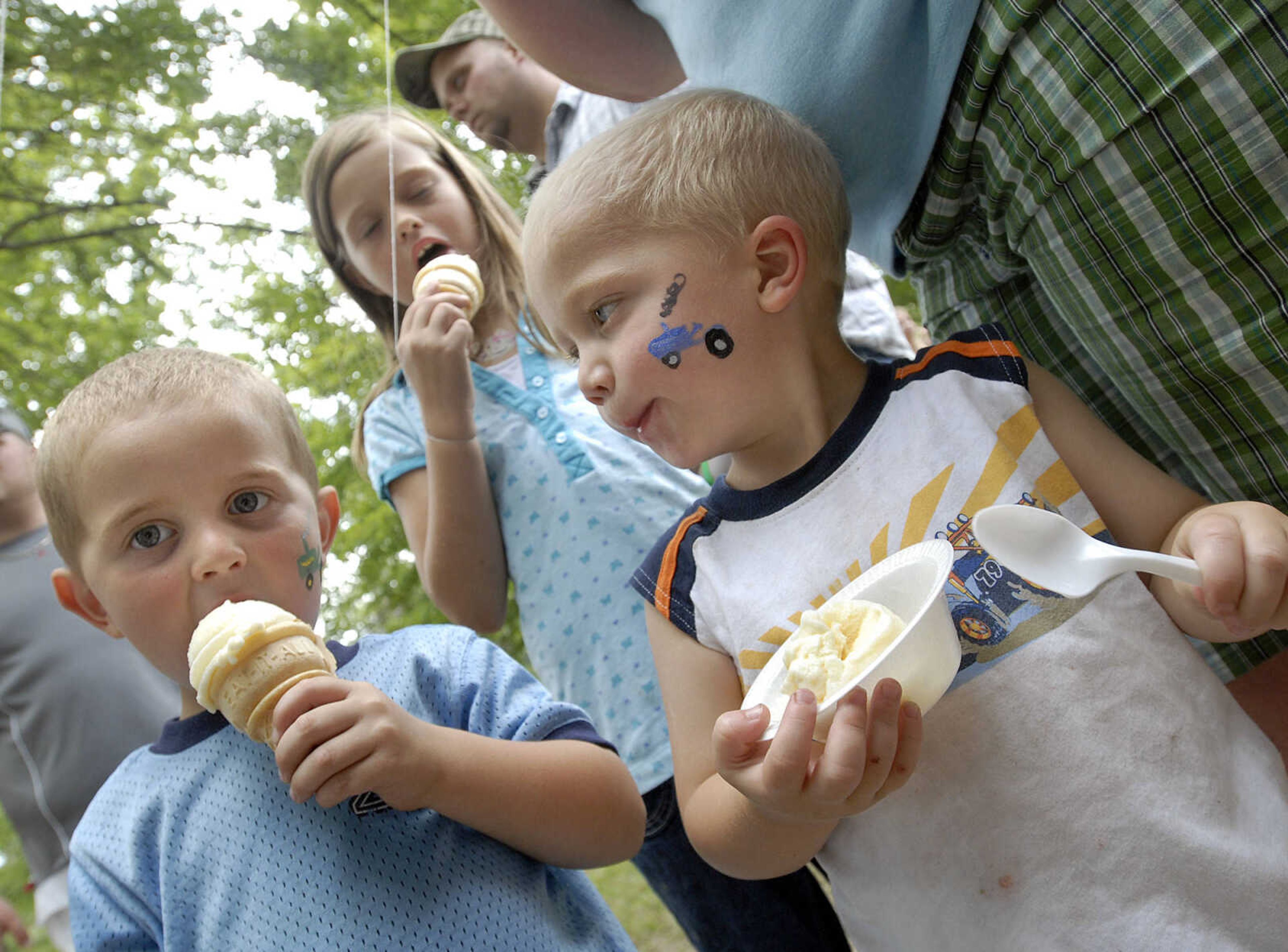 These youngsters enjoy some ice cream before dinner, including Austin Broshuis, left, Garrett Macke and Jessica Hester at the Leopold Picnic.