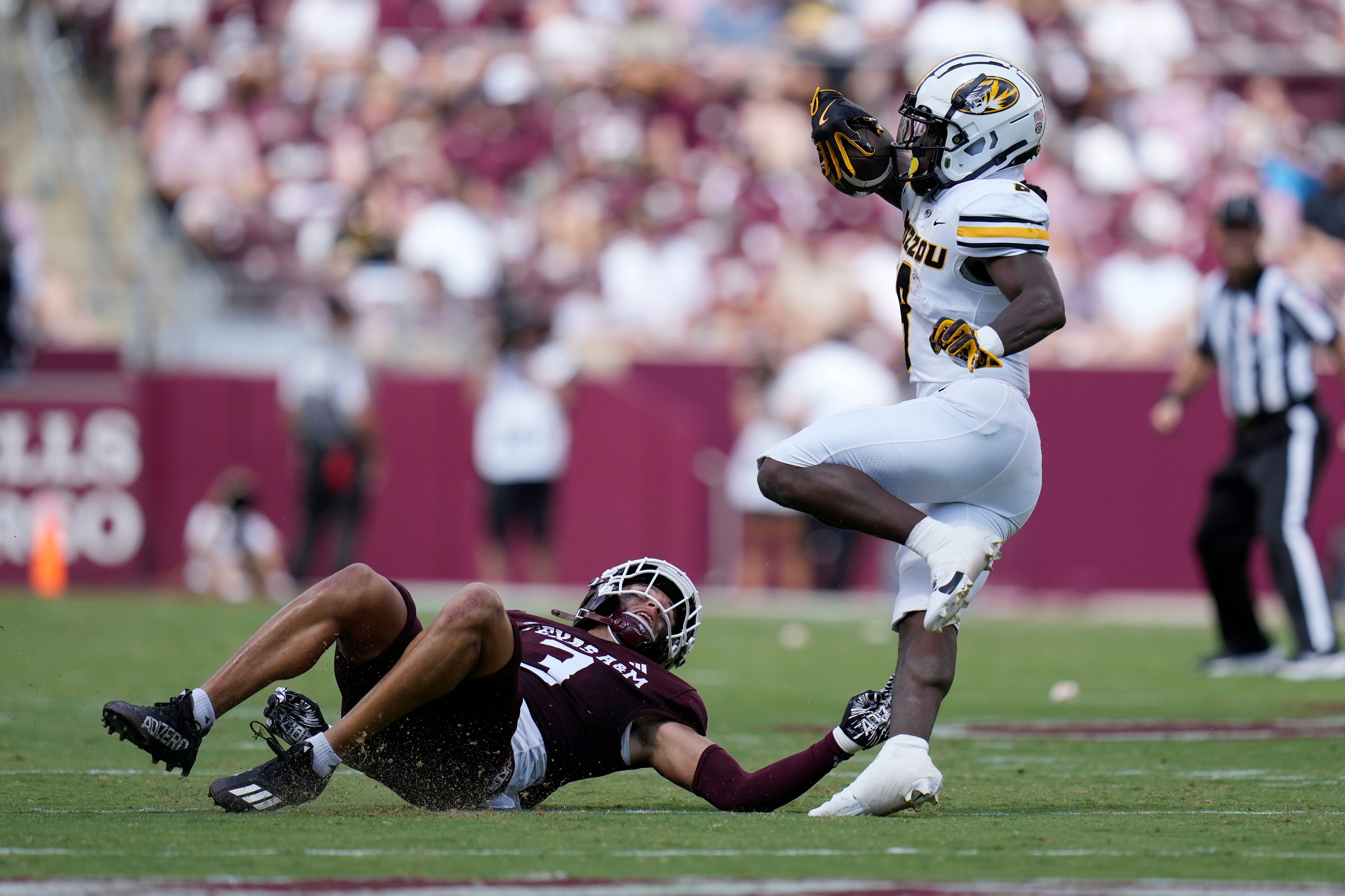 Missouri running back Nate Noel (8) tries to sidestep Texas A&M defensive back Marcus Ratcliffe (3) during the second half of an NCAA college football game Saturday, Oct. 5, 2024, in College Station, Texas. (AP Photo/Eric Gay)