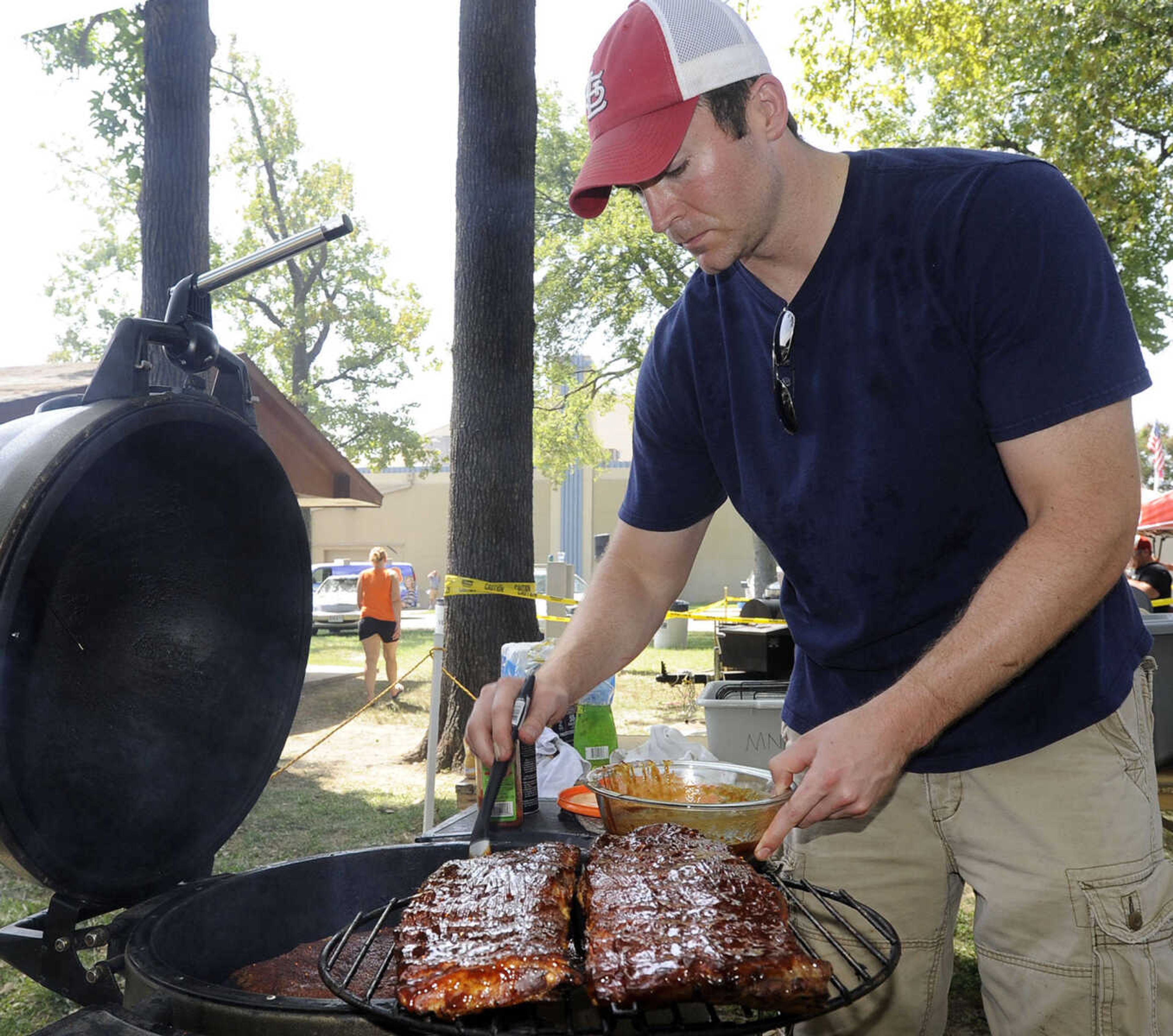 FRED LYNCH ~ flynch@semissourian.com
Brent Presser with the Cape Girardeau Noon Lions Club team prepares ribs for judging Saturday, Aug. 23, 2014 at the Cape BBQ Fest in Arena Park.