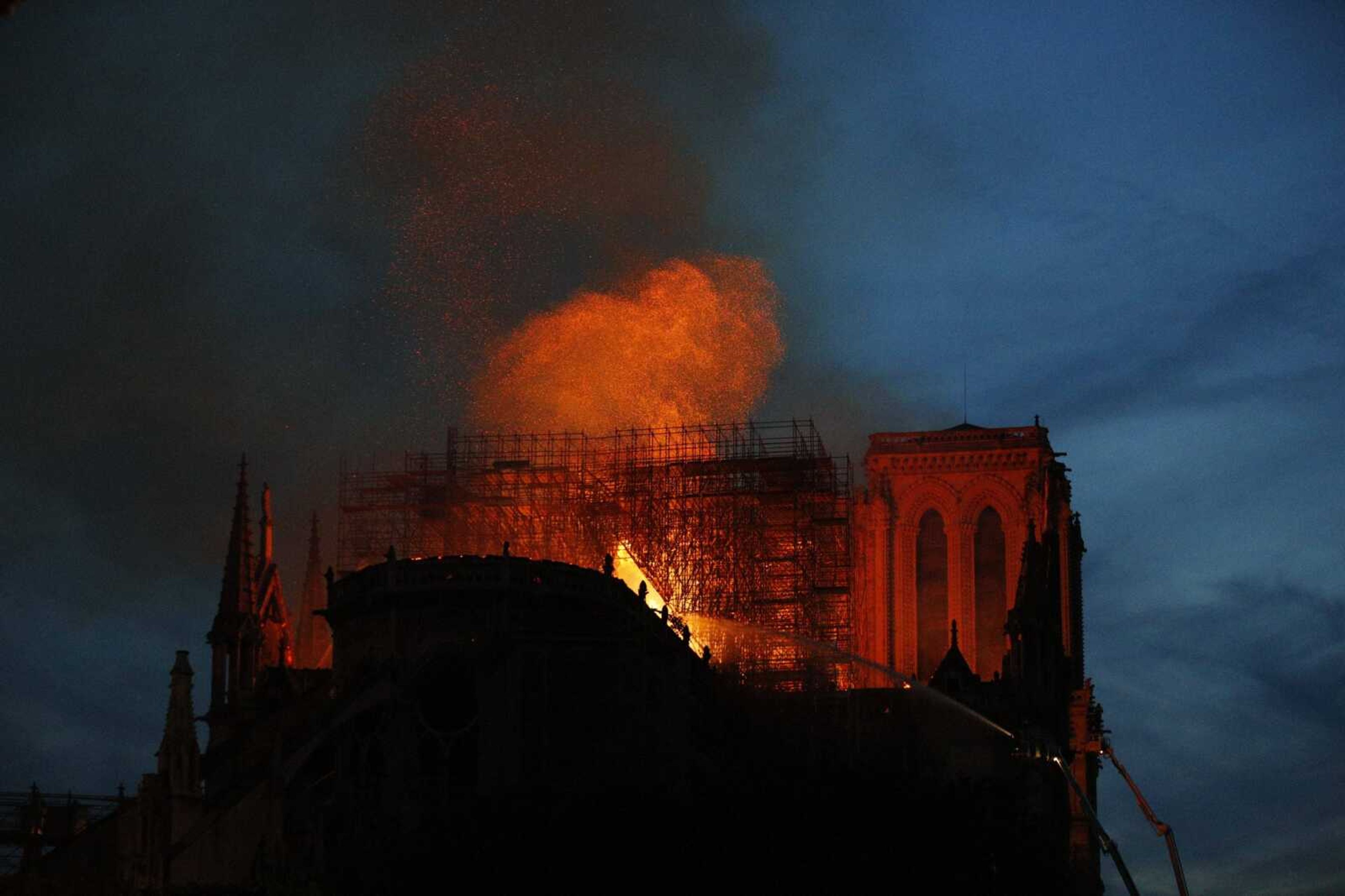 Firefighters use hoses as Notre Dame cathedral burns in Paris, Monday, April 15, 2019. A catastrophic fire engulfed the upper reaches of Paris' soaring Notre Dame Cathedral as it was undergoing renovations Monday, threatening one of the greatest architectural treasures of the Western world as tourists and Parisians looked on aghast from the streets below. (AP Photo/Francois Mori)