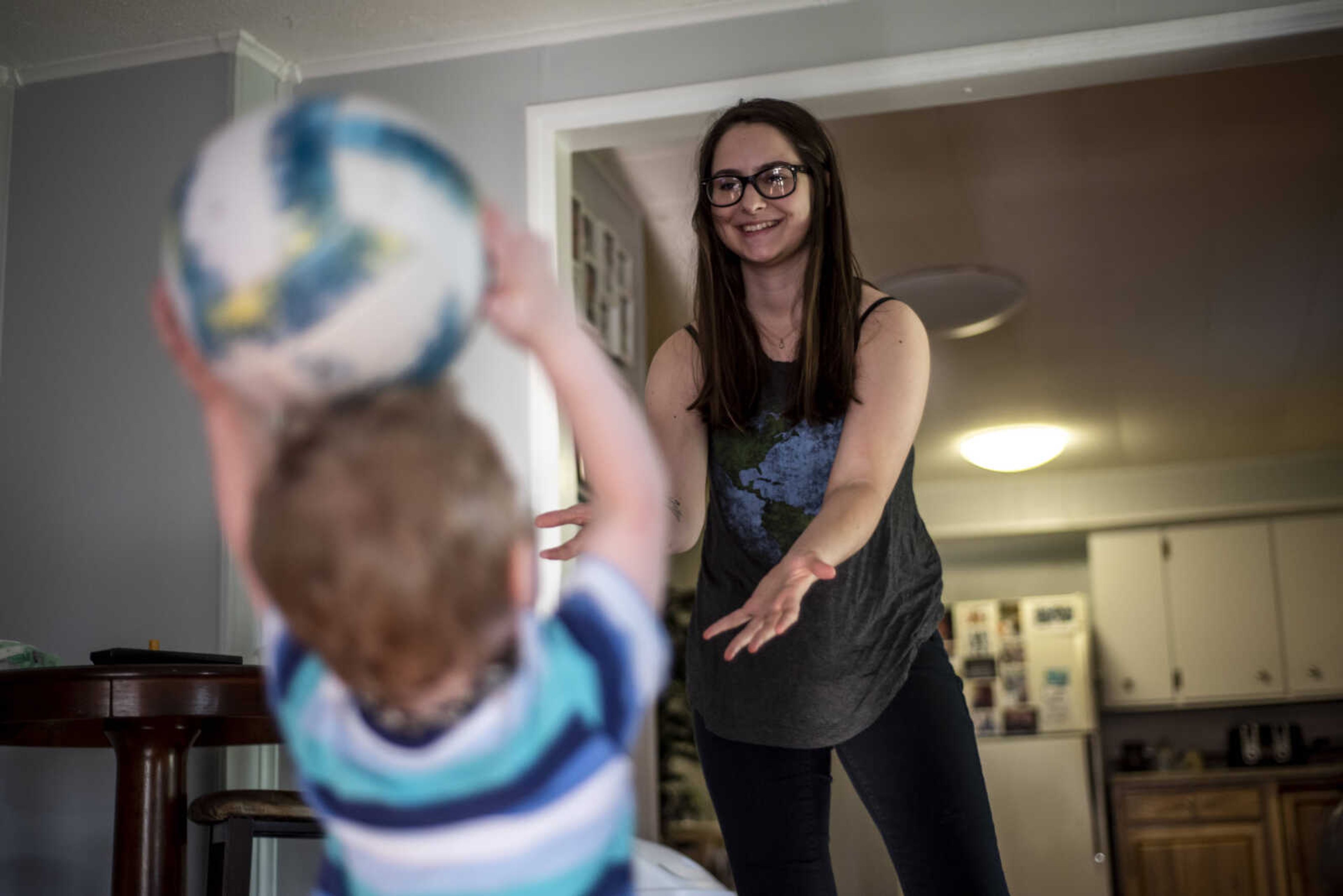 Emily Medlock holds her arms out to catch a ball from her son, Phoenix Young, 2, at home Tuesday, May 7, 2019, in Cape Girardeau.