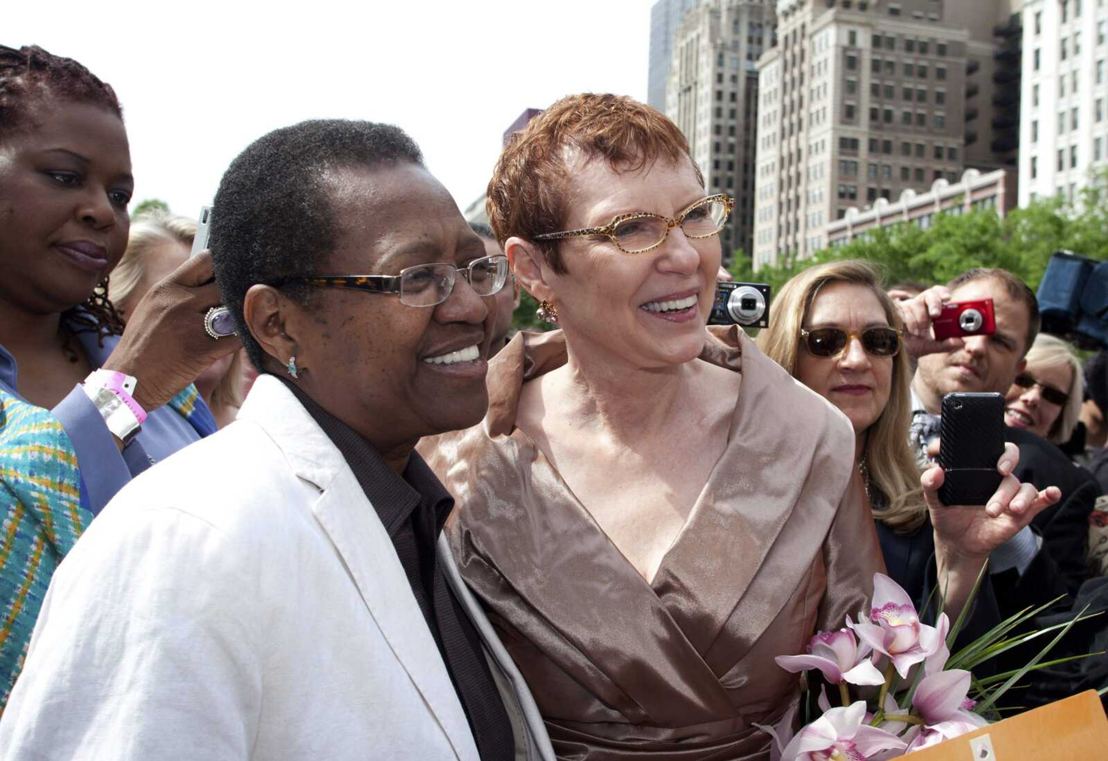 Vernita Gray, left, and Patricia Ewert smile during their civil union ceremony in 2010 at Millennium Park in Chicago. U.S. District Judge Thomas Durkin on Monday ordered the Cook County clerk to issue an expedited marriage license to Gray and Ewert before the state&#8217;s gay marriage law takes effect in June. Gray is terminally ill. (Timmy Samuel ~ Starbelly Studios / AP)