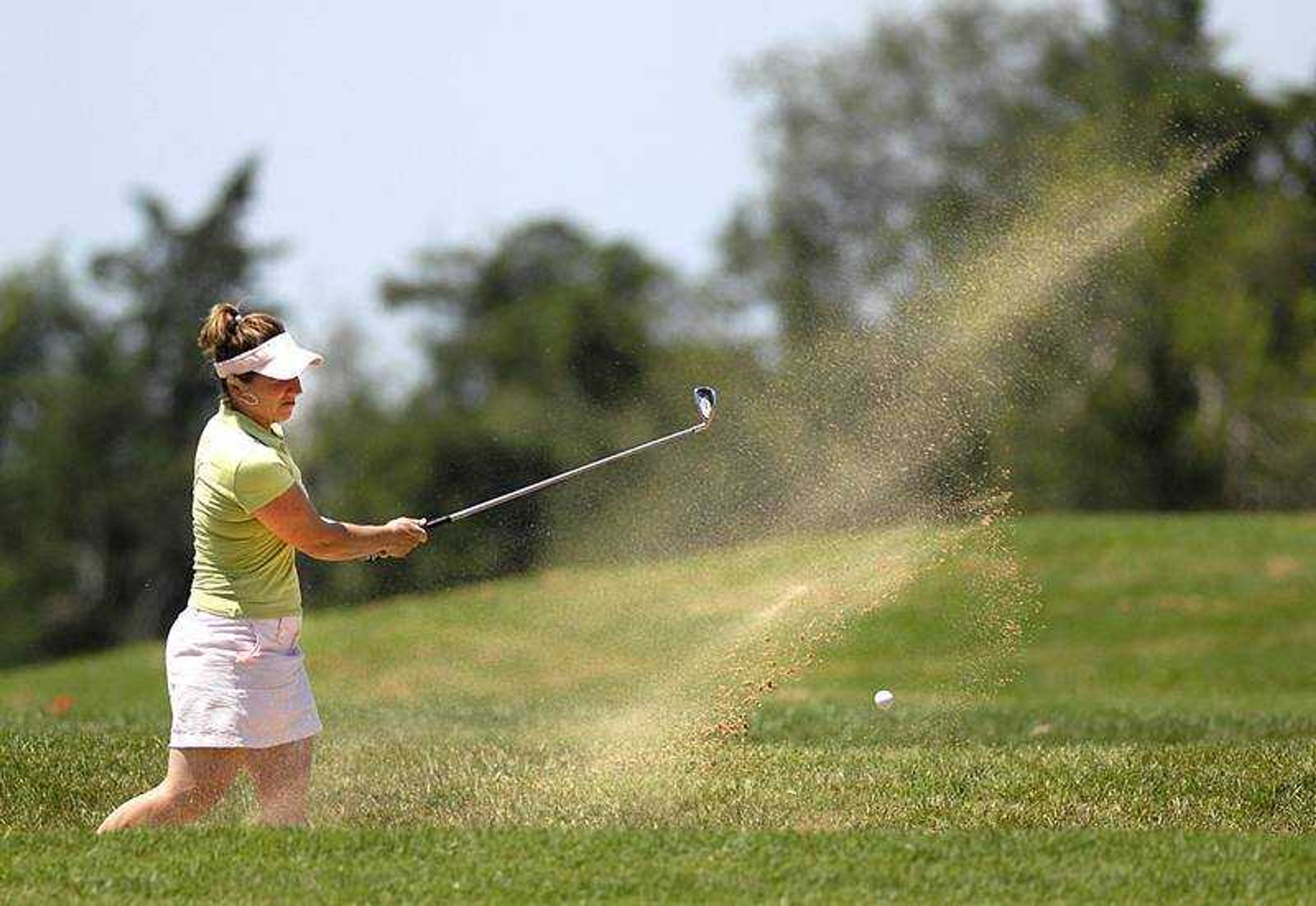 AARON EISENHAUER ~ aeisenhauer@semissourian.com
Sand flew as Jan Schultz knocked the ball from the sand trap Thursday during the second round of the Lassies Classic at the Cape Girardeau Country Club.