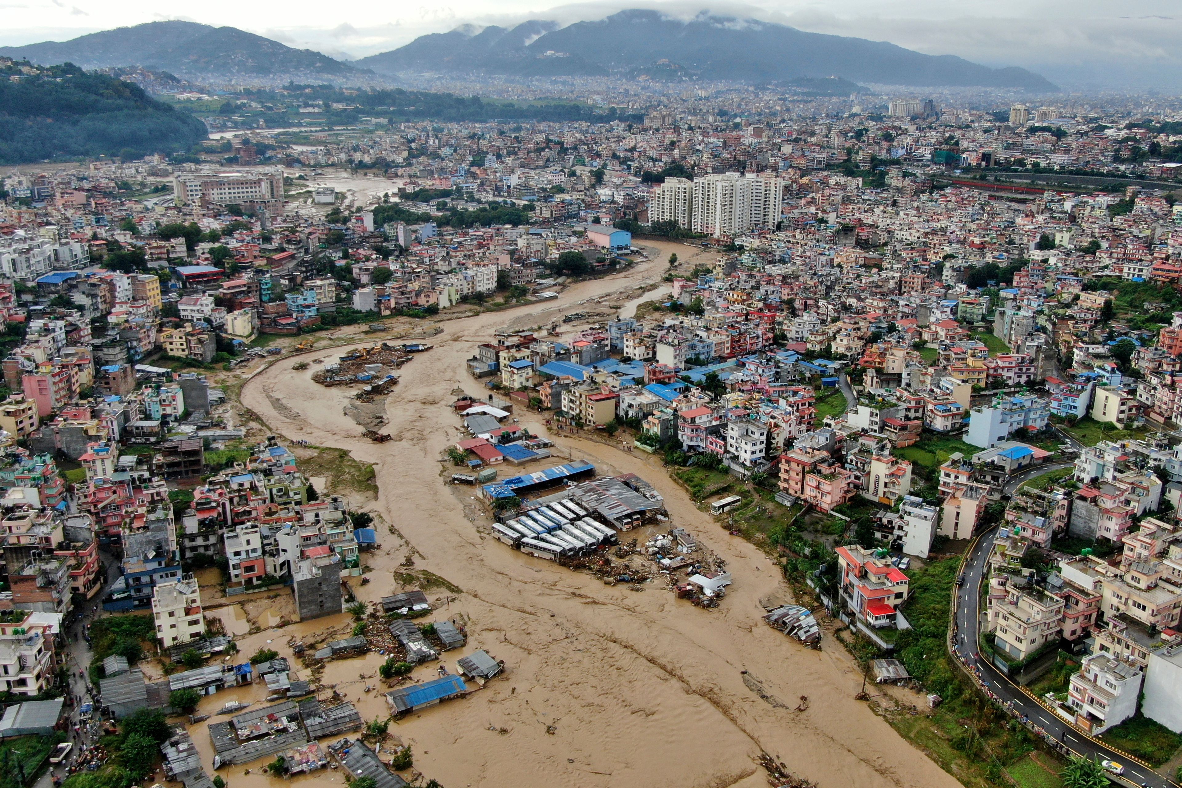 In this aerial image of the Kathmandu valley, Bagmati River is seen flooded due to heavy rains in Kathmandu, Nepal, Saturday, Sept. 28, 2024. (AP Photo/Gopen Rai)