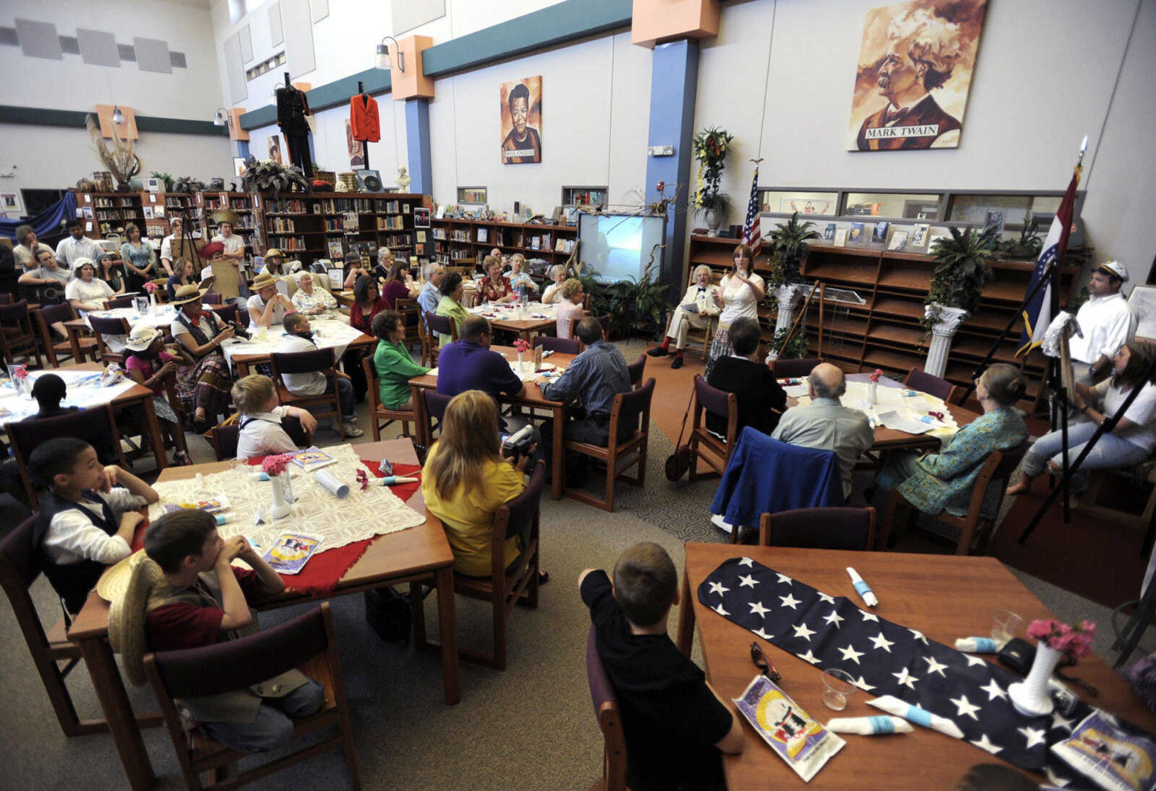 FRED LYNCH ~ flynch@semissourian.com
The audience watches Jasmine Roberts perform with a small globe during the Mark Twain Centennial event Tuesday in the library at Central High School.