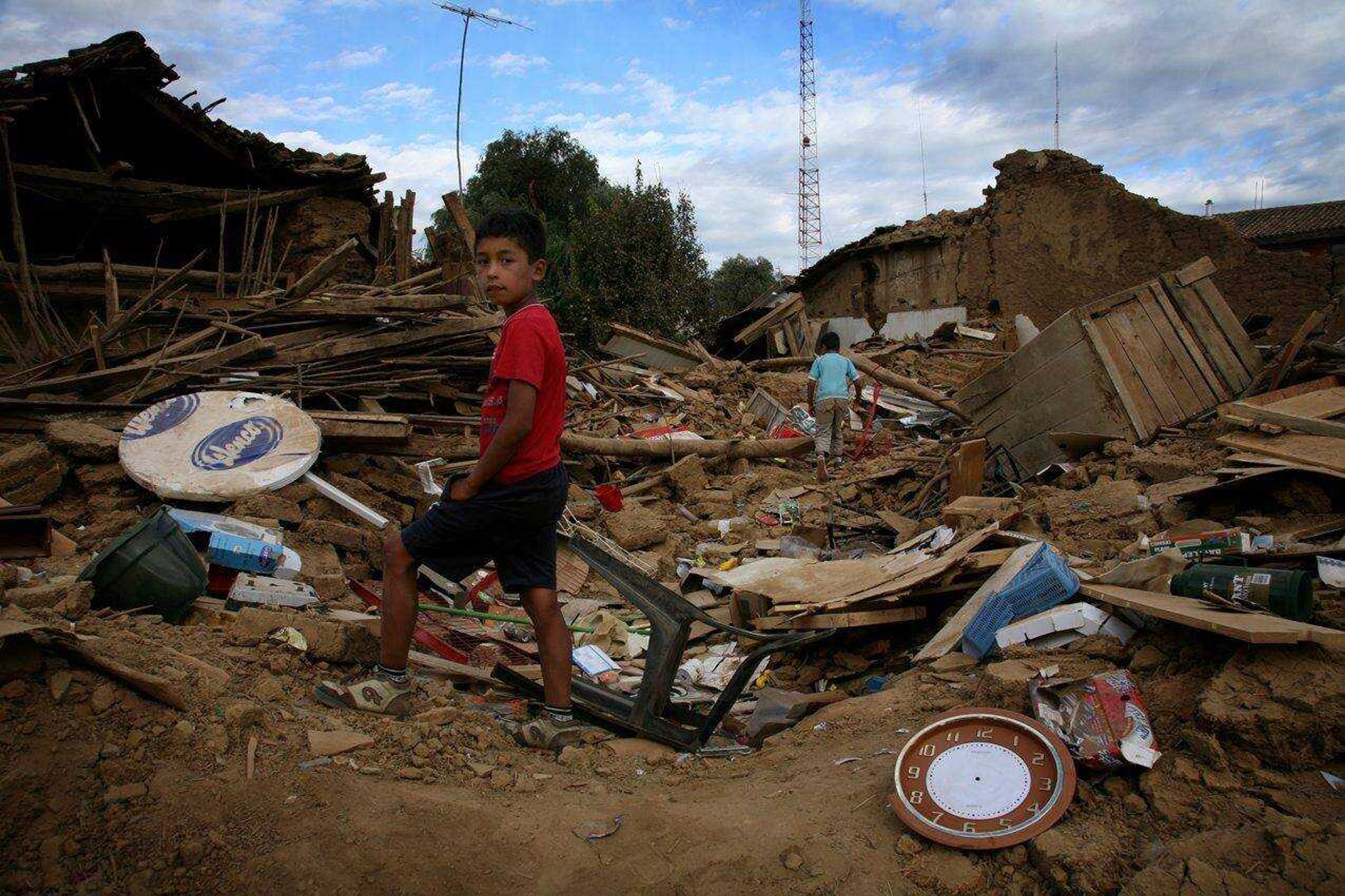 Children in Curepto, Chile, walk Saturday among rubble left by the magnitude-8.8 earthquake that struck Feb. 27. (Alexis Diaz ~ Associated Press)