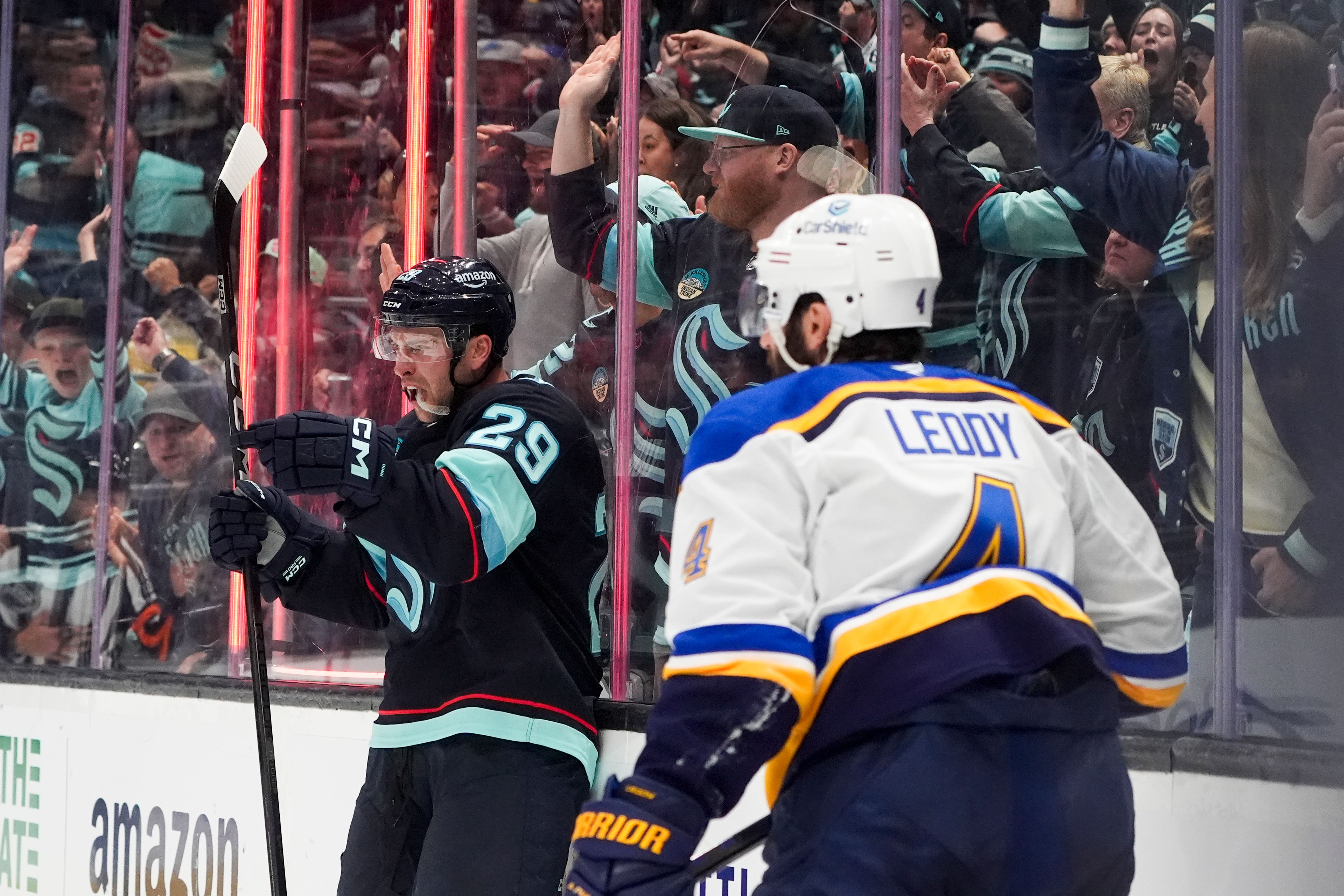 Seattle Kraken defenseman Vince Dunn reacts to scoring as St. Louis Blues defenseman Nick Leddy (4) looks on during the second period of an NHL hockey game Tuesday, Oct. 8, 2024, in Seattle. (AP Photo/Lindsey Wasson)