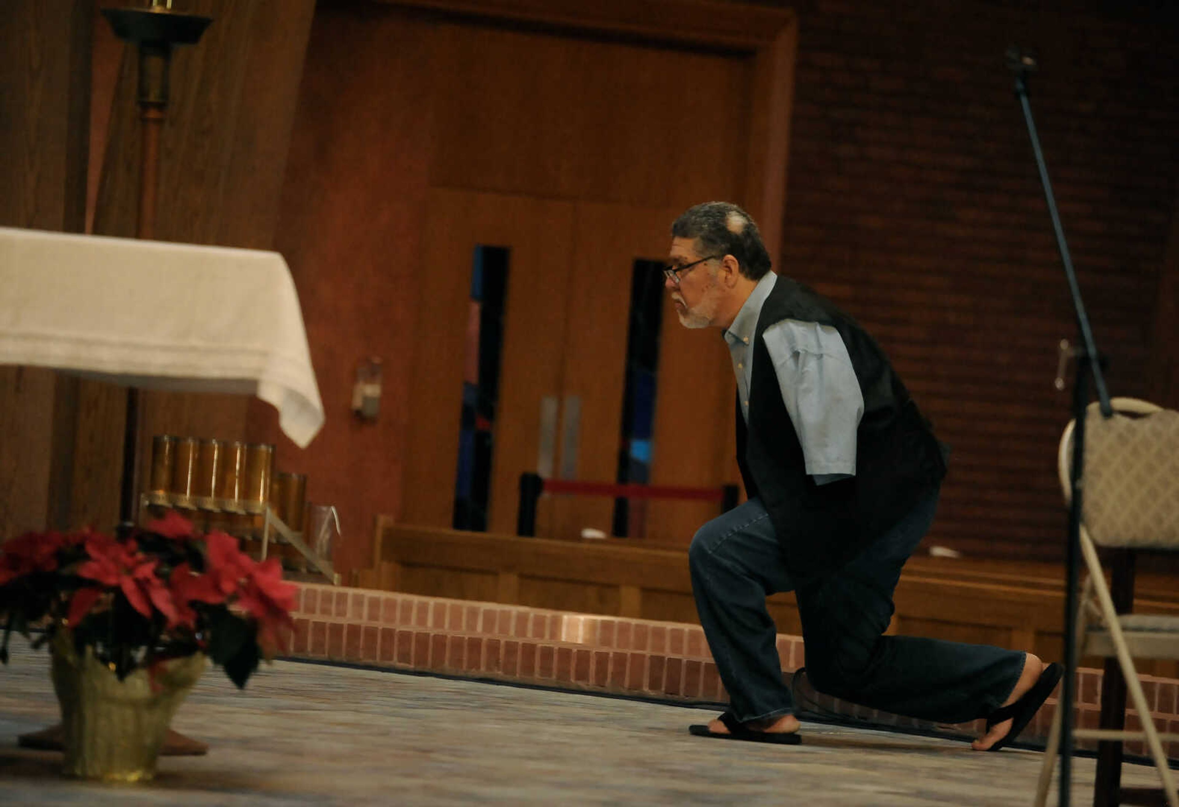 Pro-life activist and musician Tony Melendez stops to kneel in front of the cross at the St. Vincent DePaul Parish in Perryville in between performances at the inaugural March for Life Day event on Friday, Jan. 29, 2020.