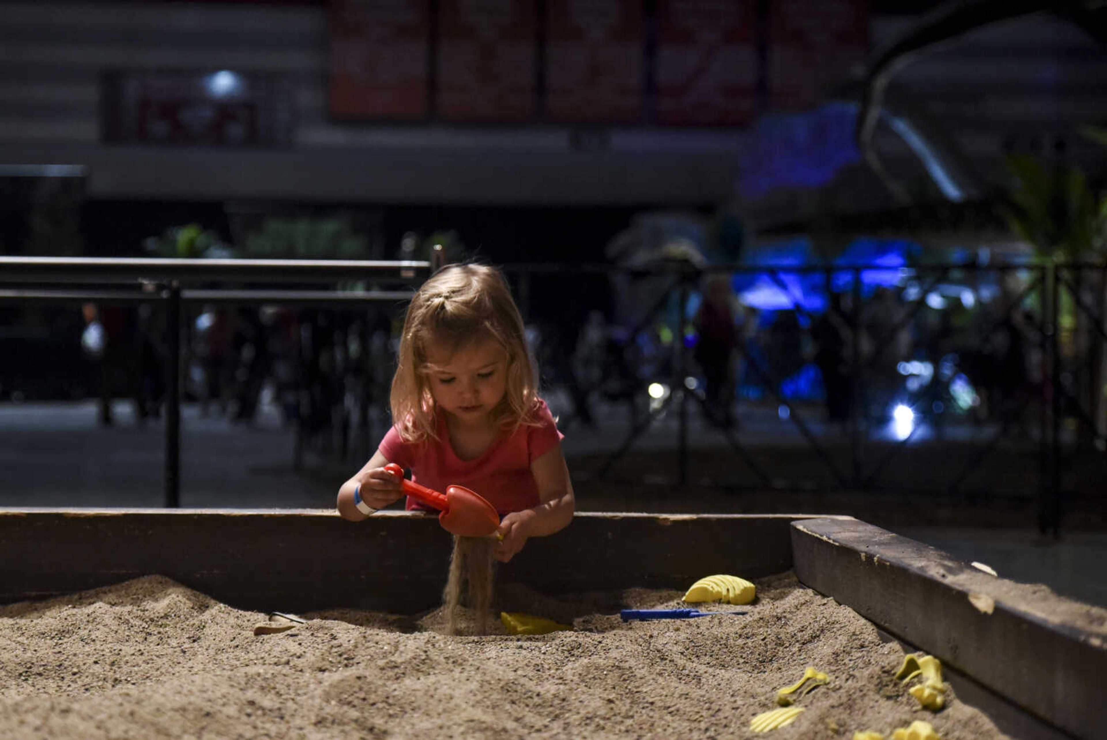 Lainey Lawson, 2, digs in the fossil sandbox at Jurassic Quest Friday, April 27, 2018, at the Show Me Center in Cape Girardeau.