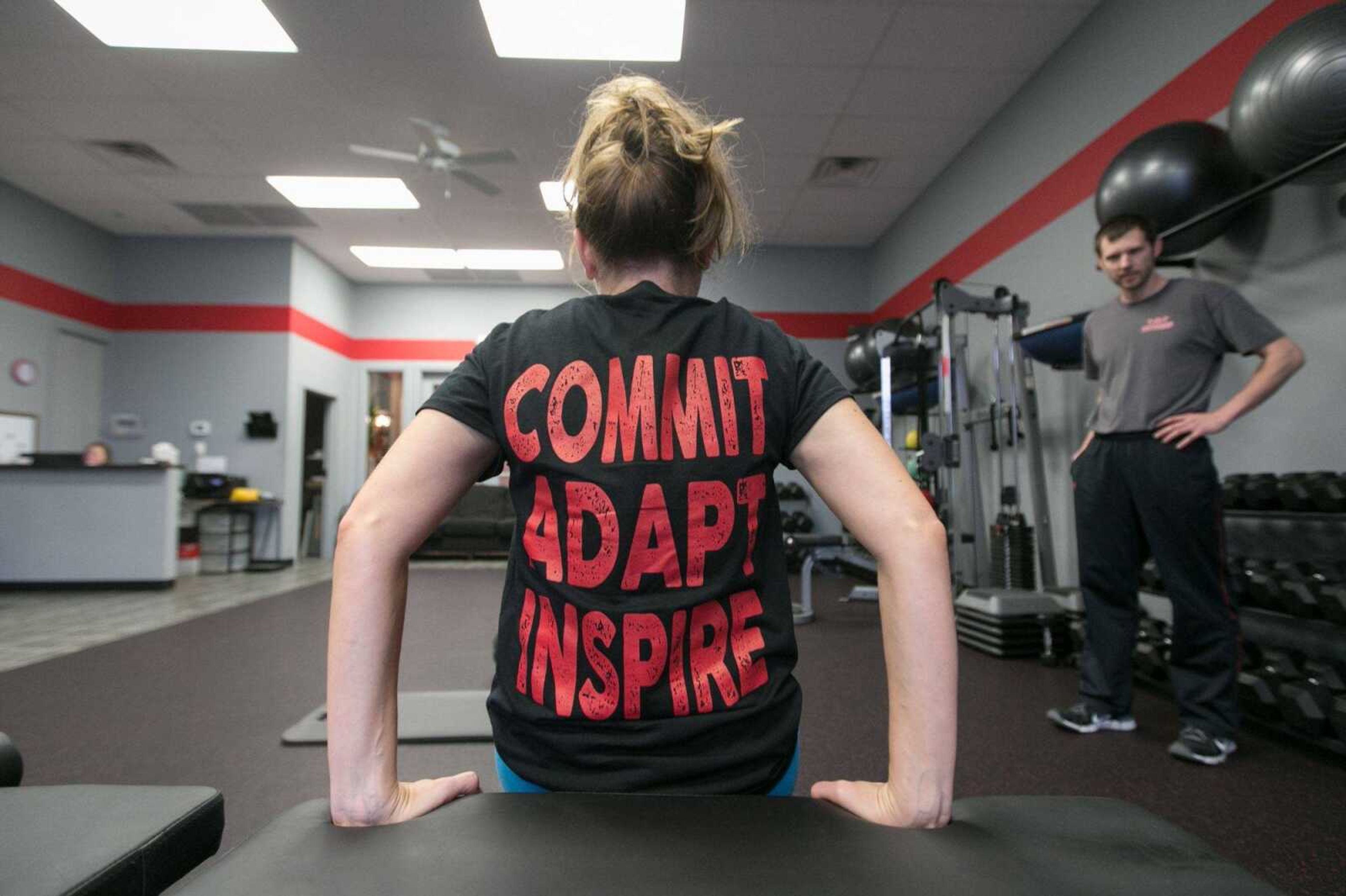 Krystal Downs performs a set of dips during her workout Dec. 23 with TNT Health and Fitness trainer and co-owner Travis Blessing. (Glenn Landberg)