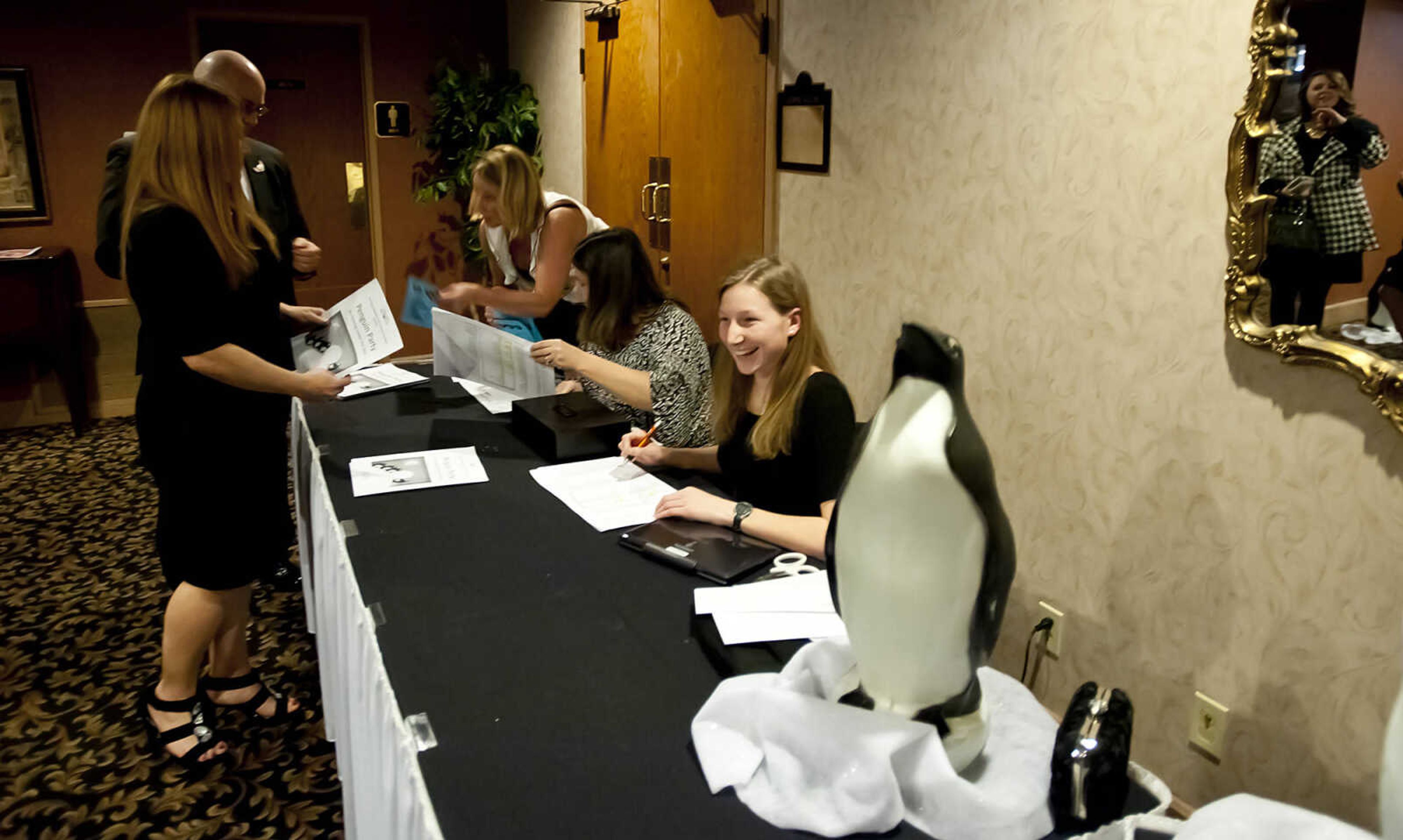 Attendees check in at the Cape Girardeau Public School Foundation Penguin Party Saturday, Feb. 8, at Plaza by Ray's in Cape Girardeau. The event, which is the foundation's annual fundraiser, featured a sit down plated dinner, a live and silent auction followed by dancing.