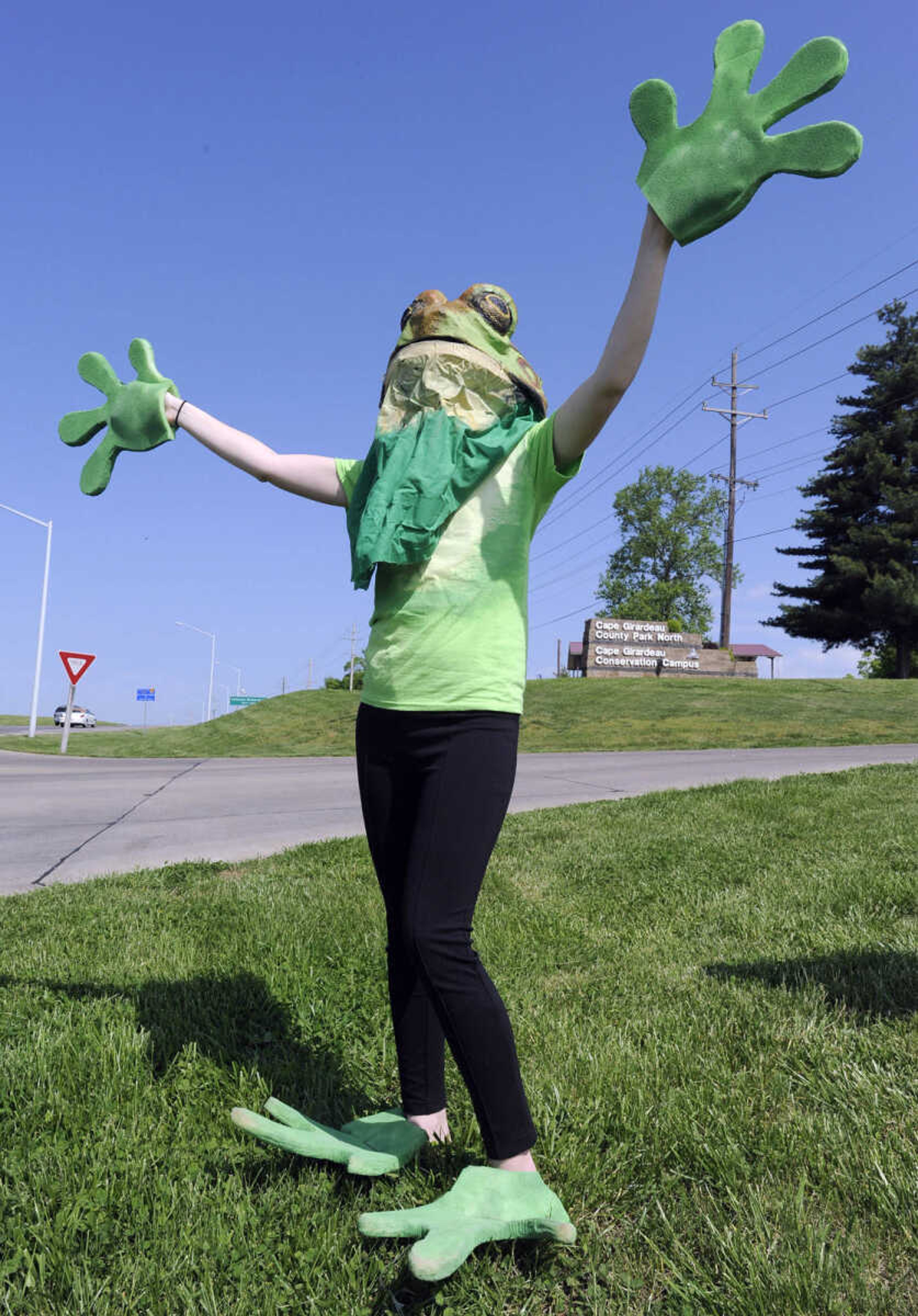 Dressed as a green frog, Madi Herrboldt welcomes visitors to the Cape Girardeau County Conservation Nature Center's 10th anniversary Saturday, May 2, 2015.