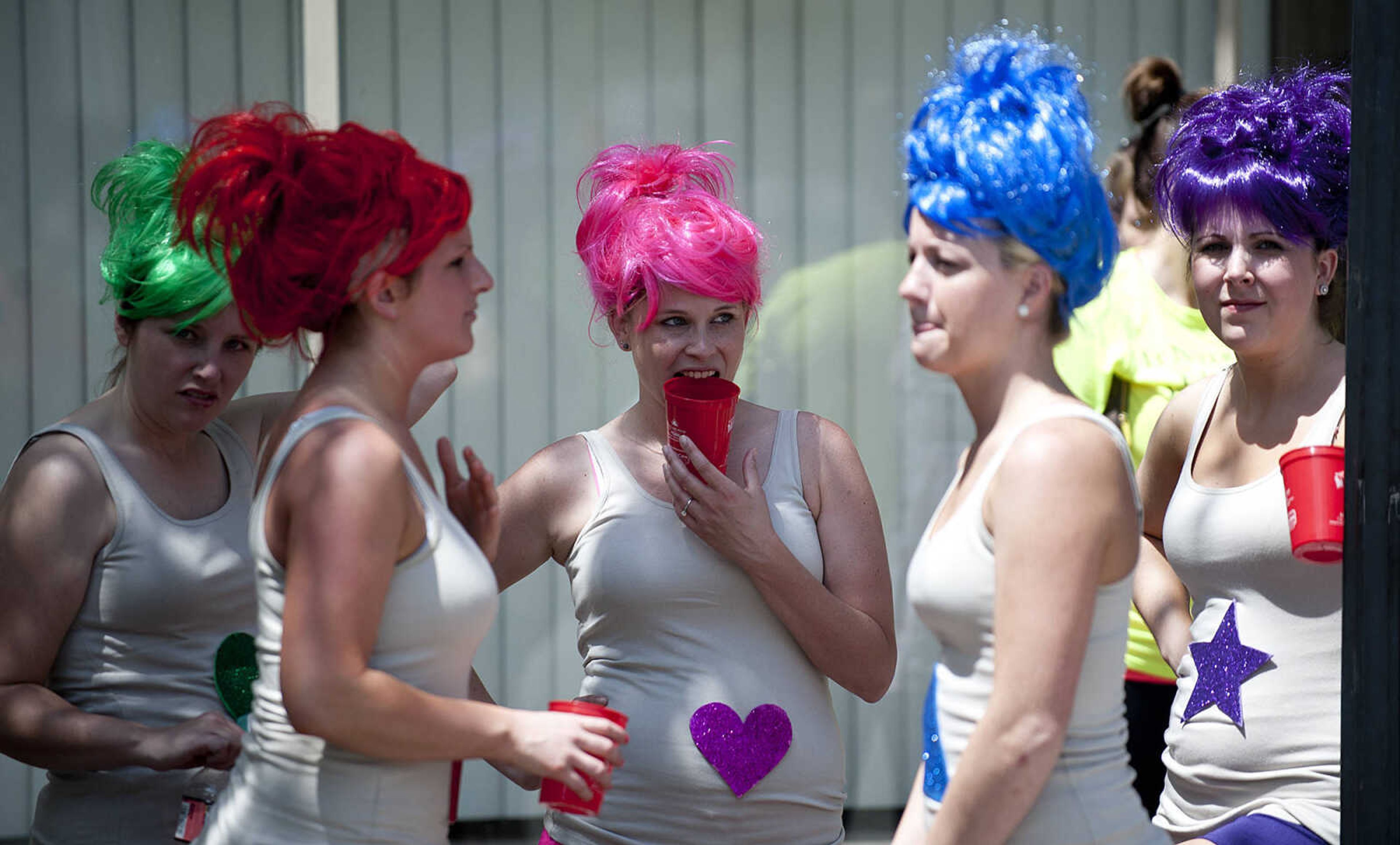 Sara Best, left, Erin Fields, Miranda Abt, Ashley Bronn and Jessica Zoellner wait to compete in the Perryville Mayfest Bed Races Saturday, May 10, in Perryville, Mo. They and their team dressed as "Treasure Trolls," for the event.