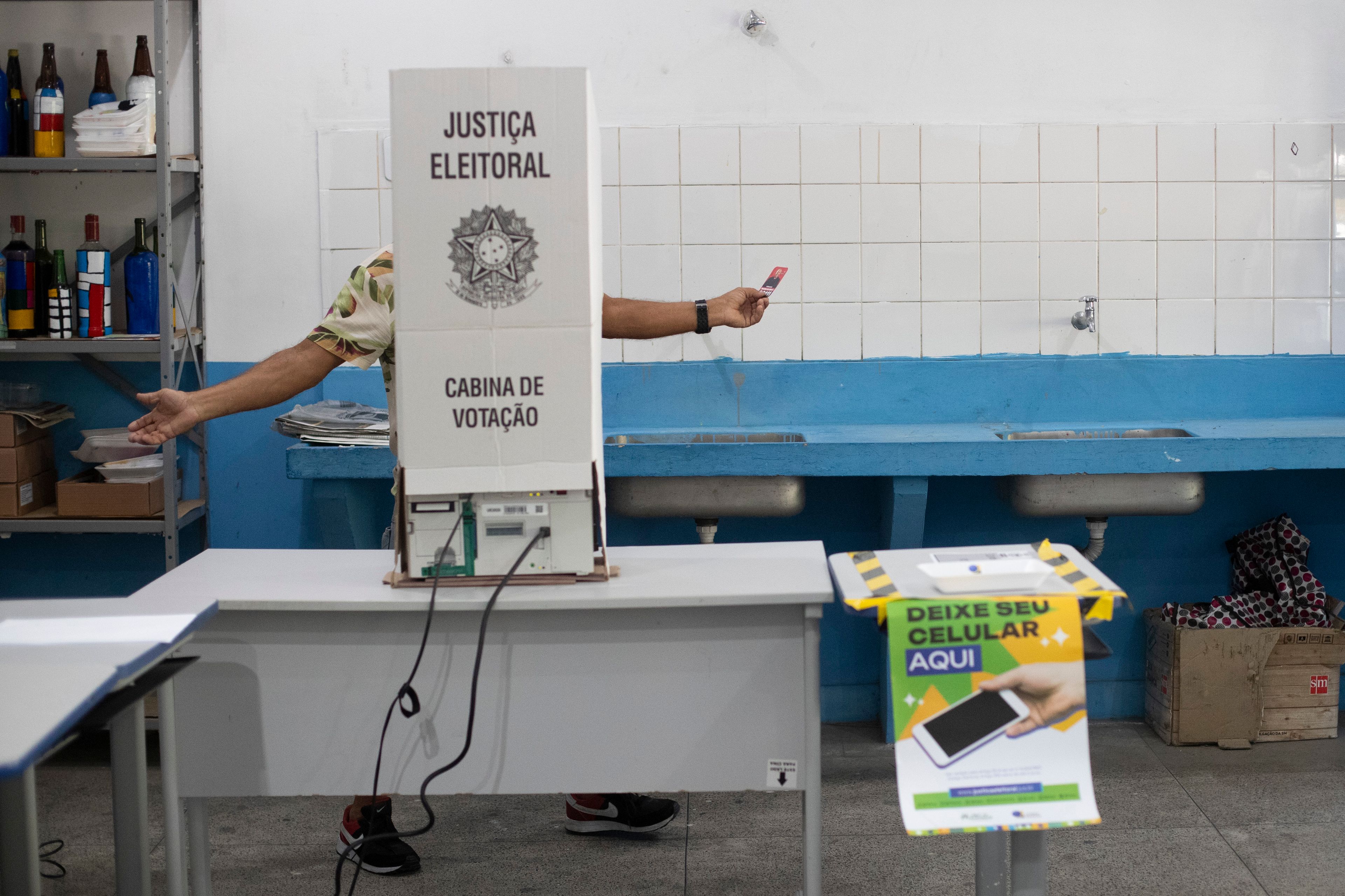 A man votes in municipal elections in the Rocinha community of Rio de Janeiro, Sunday, Oct. 6, 2024. (AP Photo/Bruna Prado)