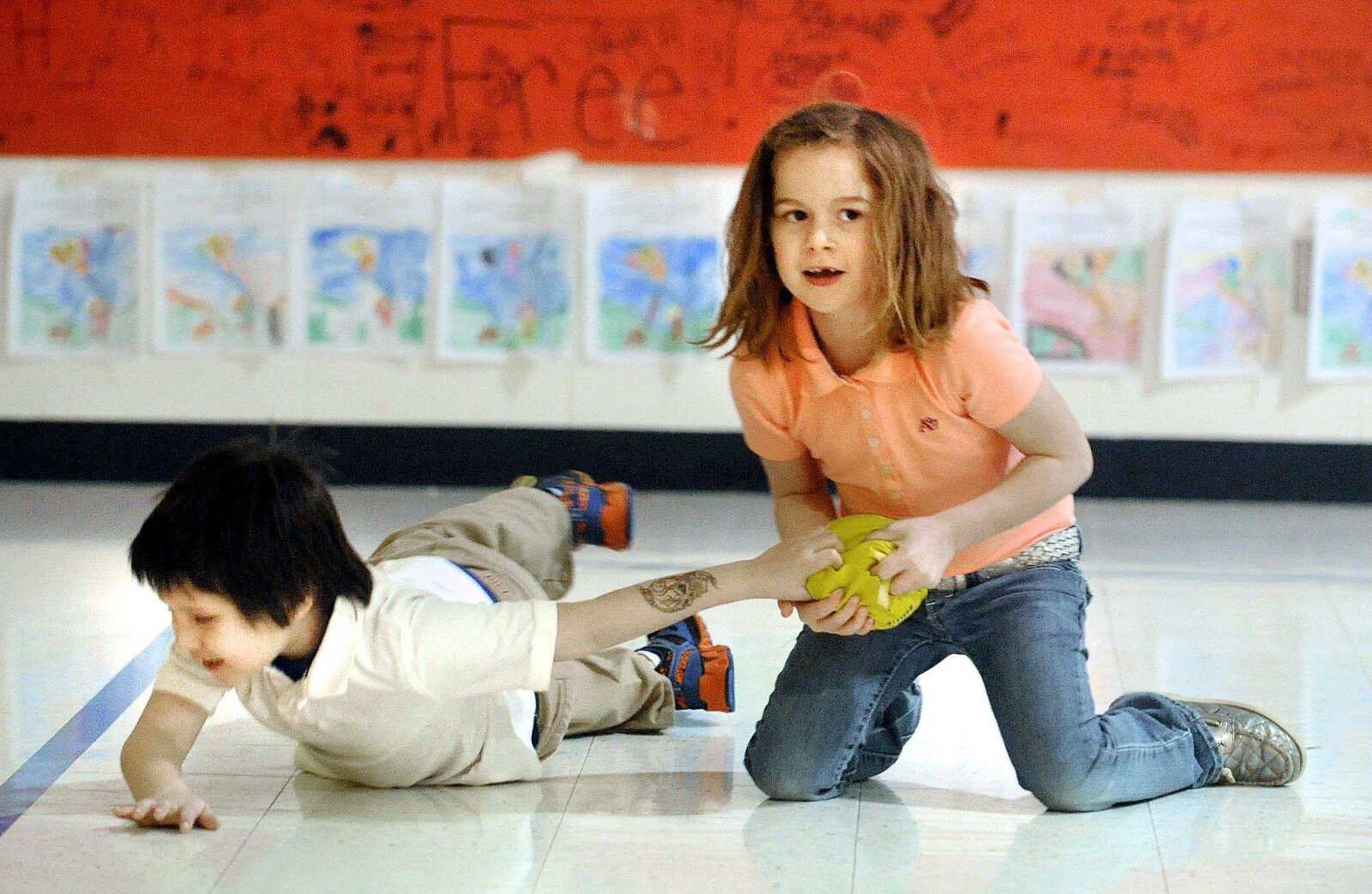 Journey Black, right, and Jacob Cassout struggle for possession of the ball while playing dodge ball during Fellowship Friday as part of The Leader in Me program Friday at Scott City Elementary School. (Laura Simon)