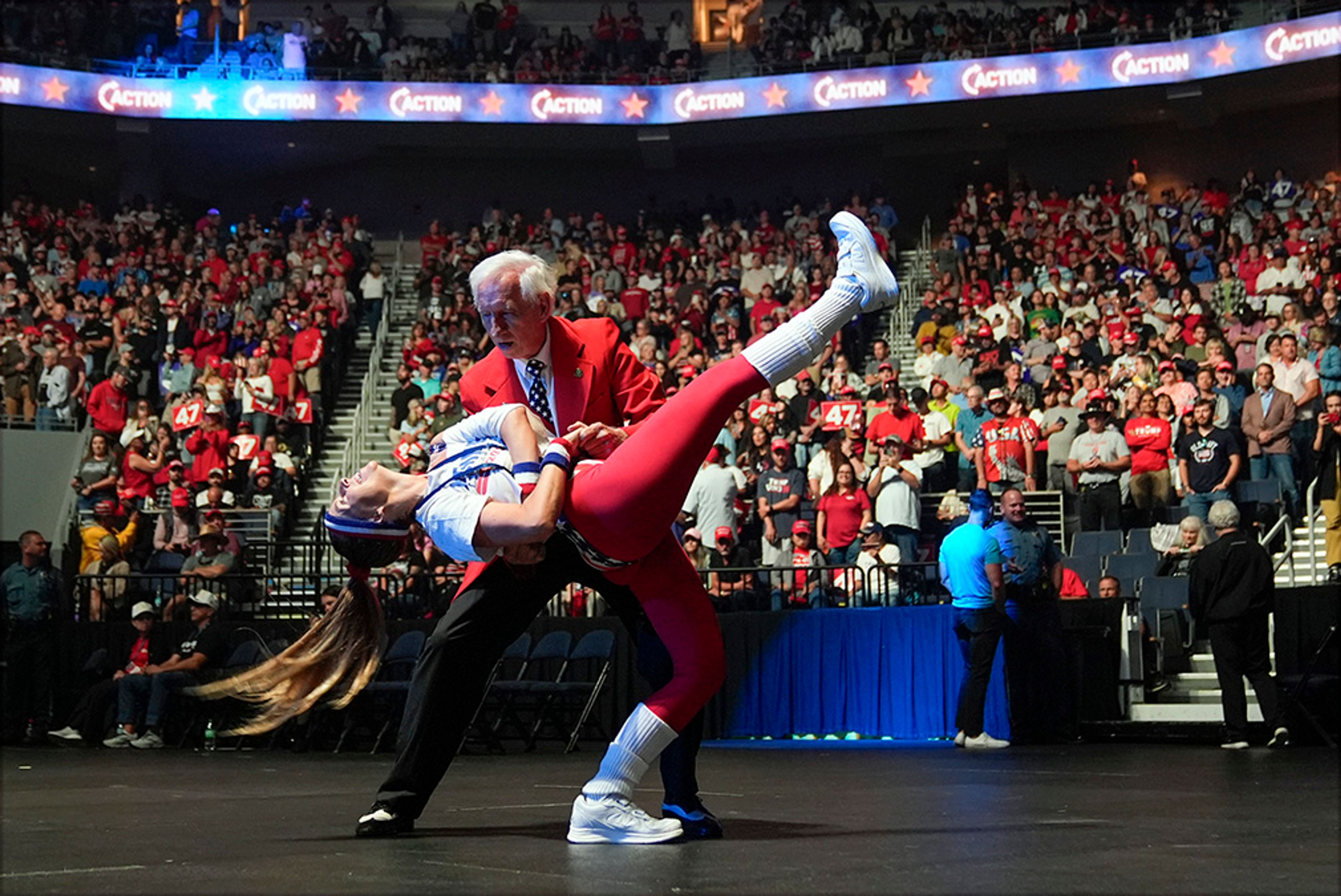 Gary Bruce and Brittany Kemper dance before Republican presidential nominee former President Donald Trump speaks at a Turning Point Action campaign rally, Wednesday, Oct. 23, 2024, in Duluth, Ga.