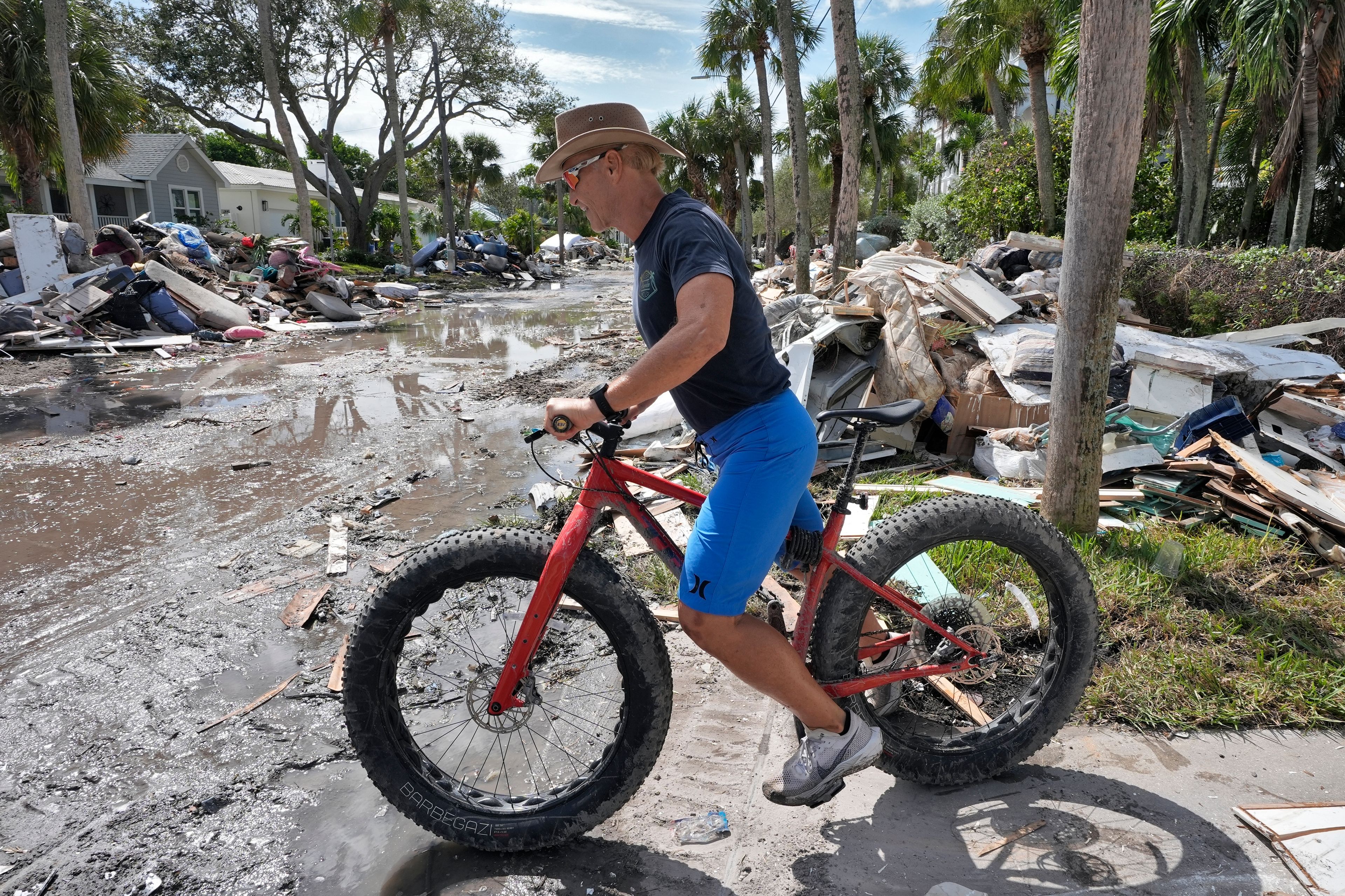 FILE - Arnie Bellini surveys the damages caused from Hurricane Helene on a street in Clearwater Beach, Fla., Oct. 8, 2024. (AP Photo/Chris O'Meara, File)